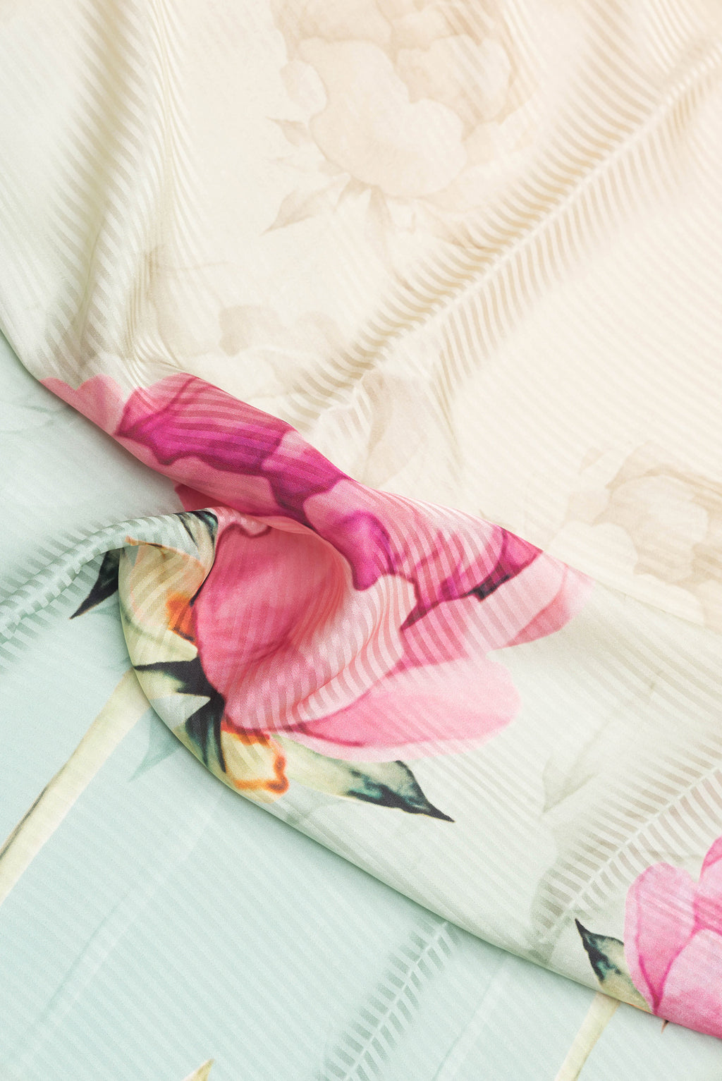 Close up of Sea Green Dual Tone Crepe Saree with Printed design on the body and Without Border.  displaying folds
