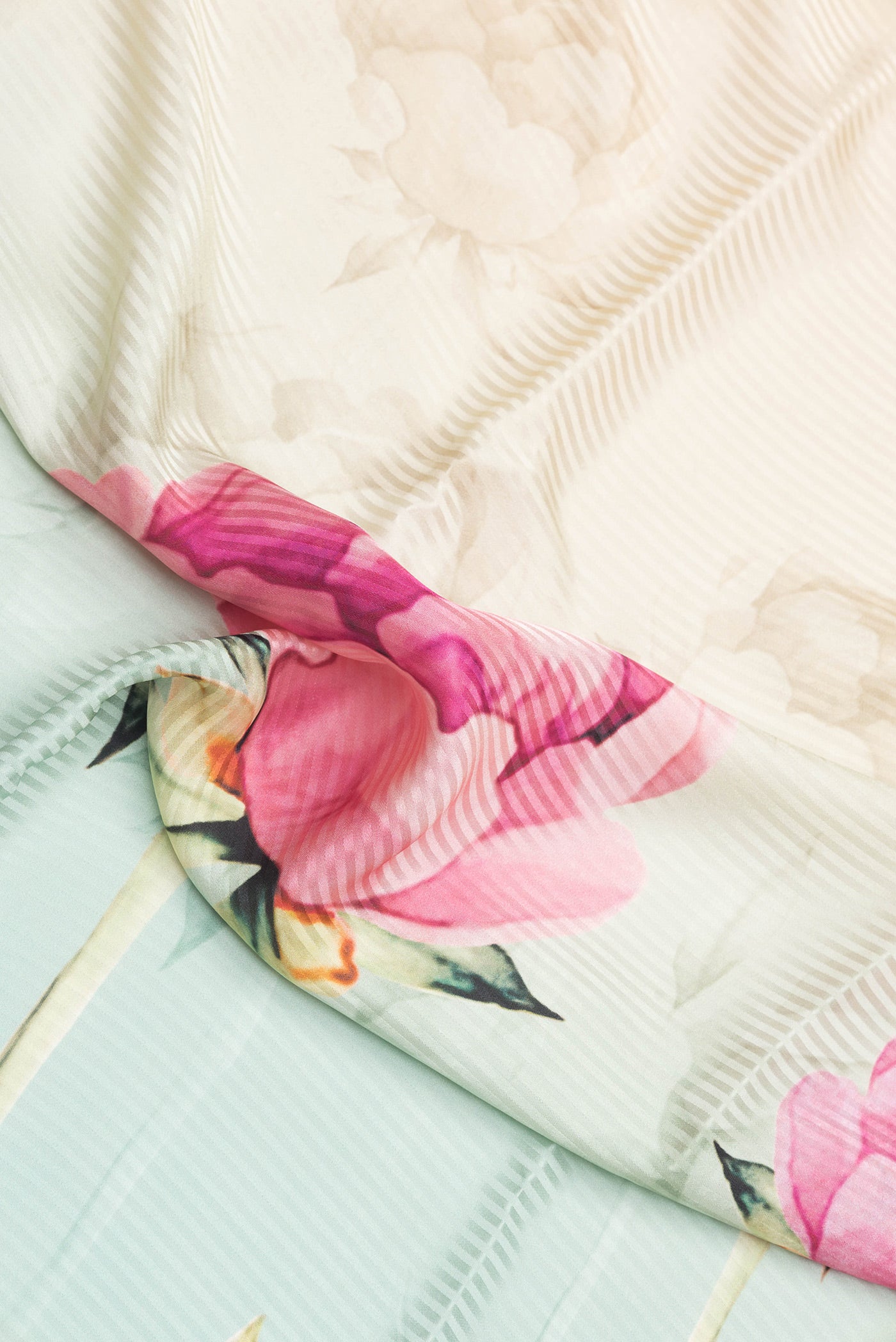 Close up of Sea Green Dual Tone Crepe Saree with Printed design on the body and Without Border.  displaying folds
