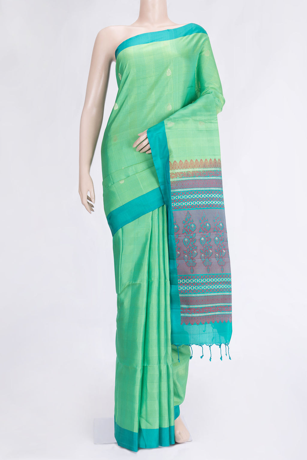 Pista Green Dual Tone Soft Silk Saree with Zari Butta on the body and Plain Border.  displayed on a mannequin