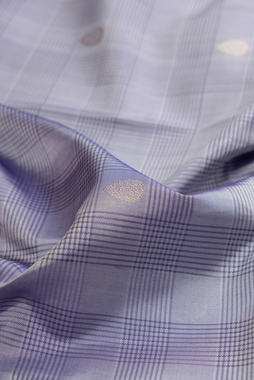 Close up of Grey Soft Silk Saree with Checked design on the body and Plain Border.  displaying folds
