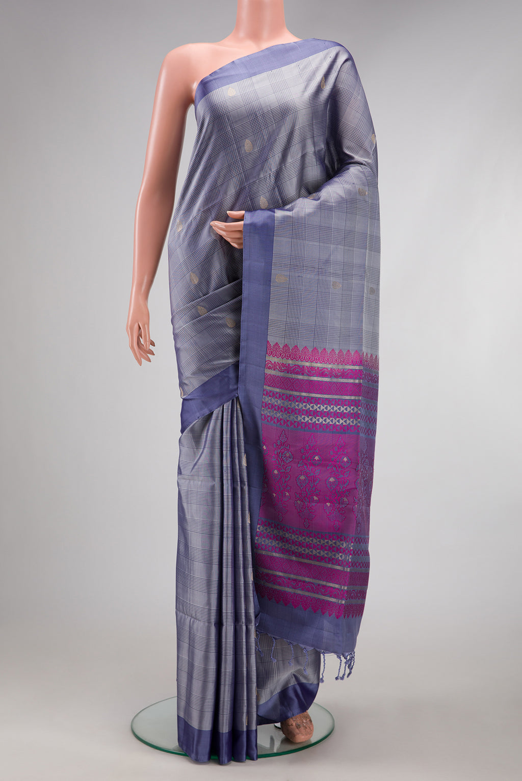 Grey Soft Silk Saree with Checked design on the body and Plain Border.  displayed on a mannequin