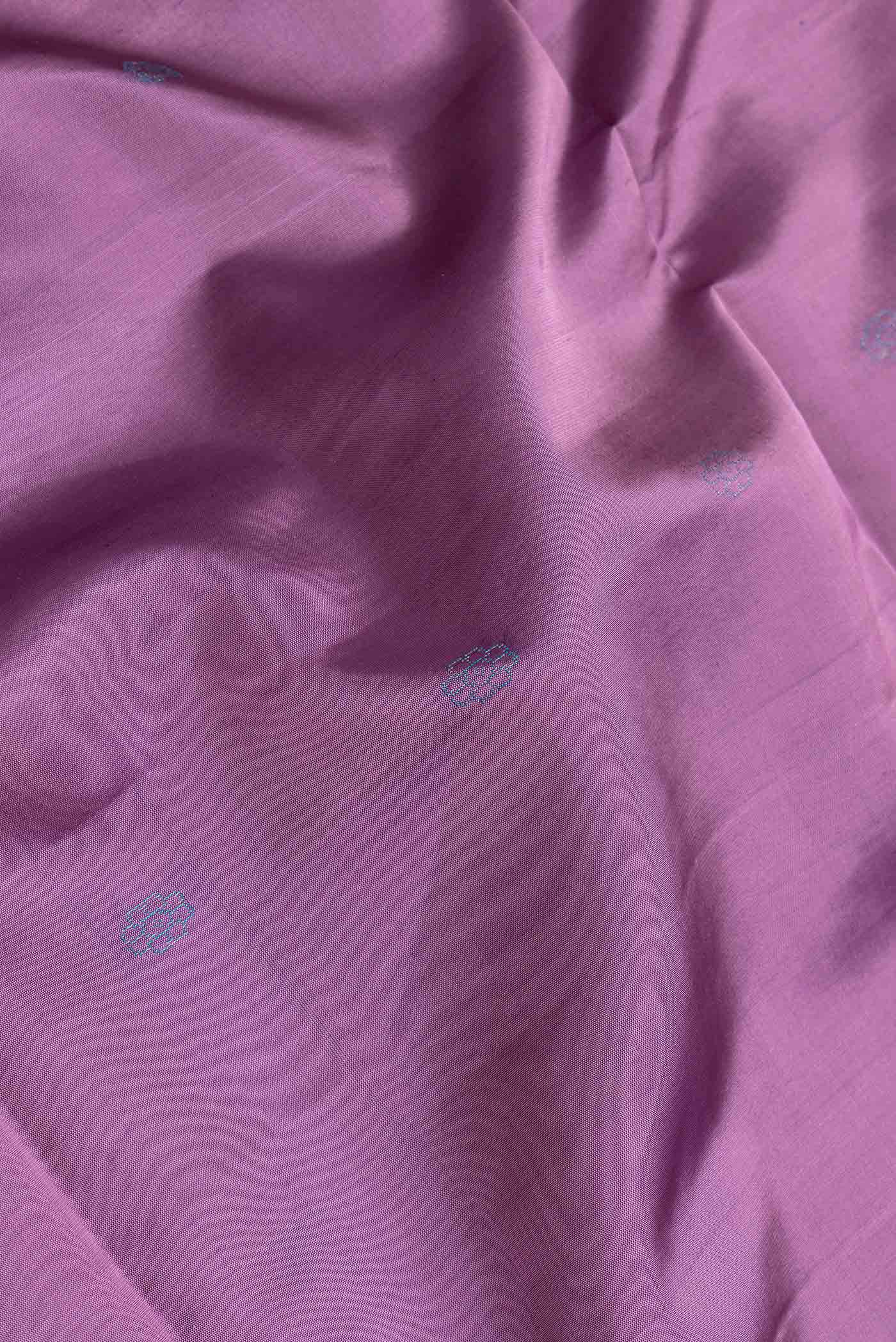 Close up of Purple Dual Tone Soft Silk Saree with Zari Butta on the body and Thin Zari Line.  displaying folds