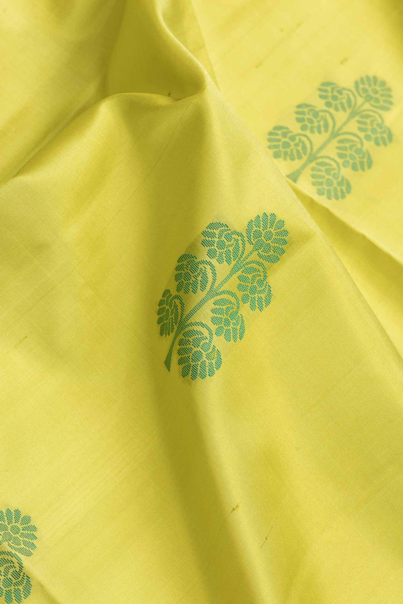Close up of Lemon Yellow Dual Tone Soft Silk Saree with Thread Butta on the body and Without Border.  displaying folds