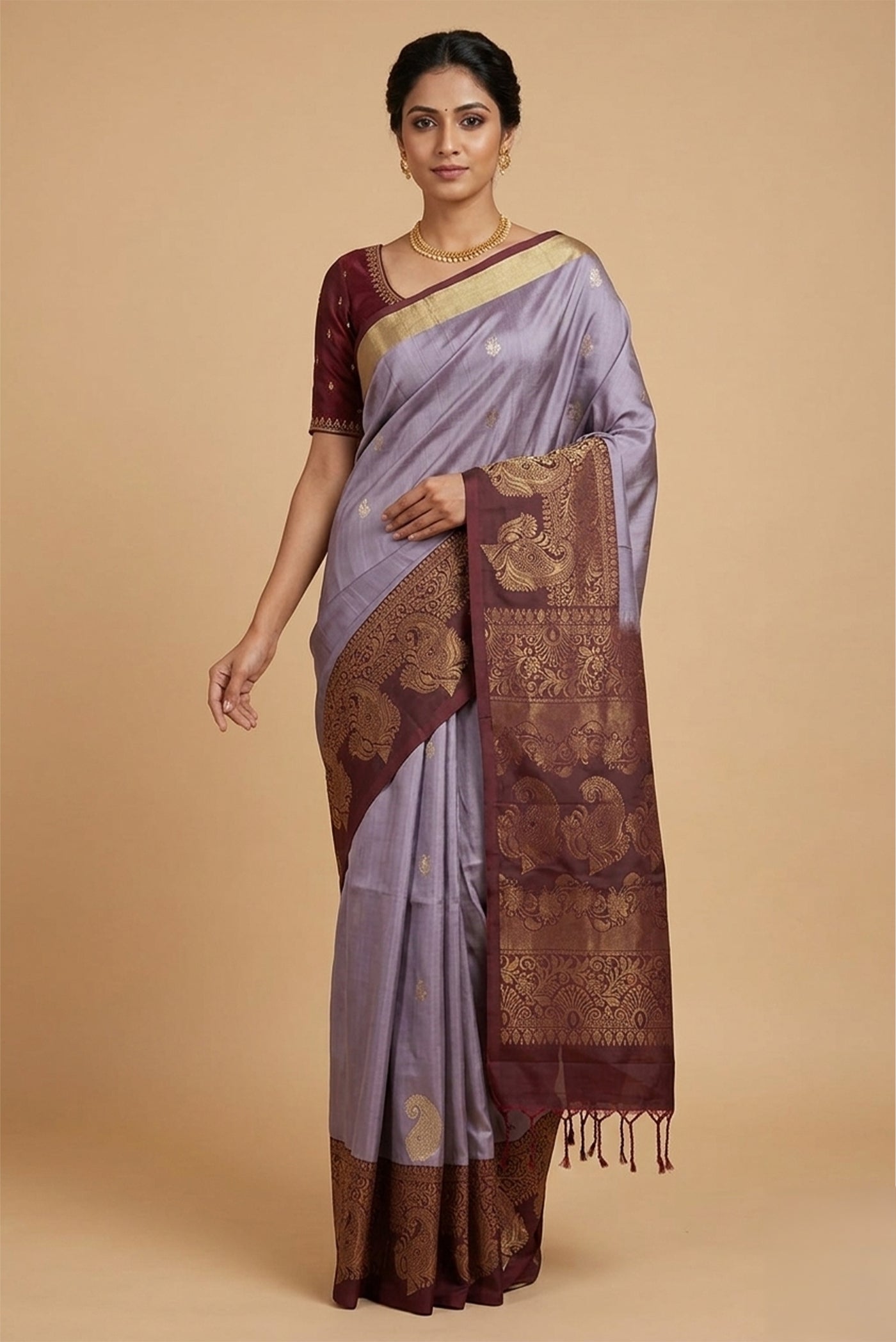 Model wearing a Lilac Soft Silk Saree with Zari Butta on the body and Zari Border.
