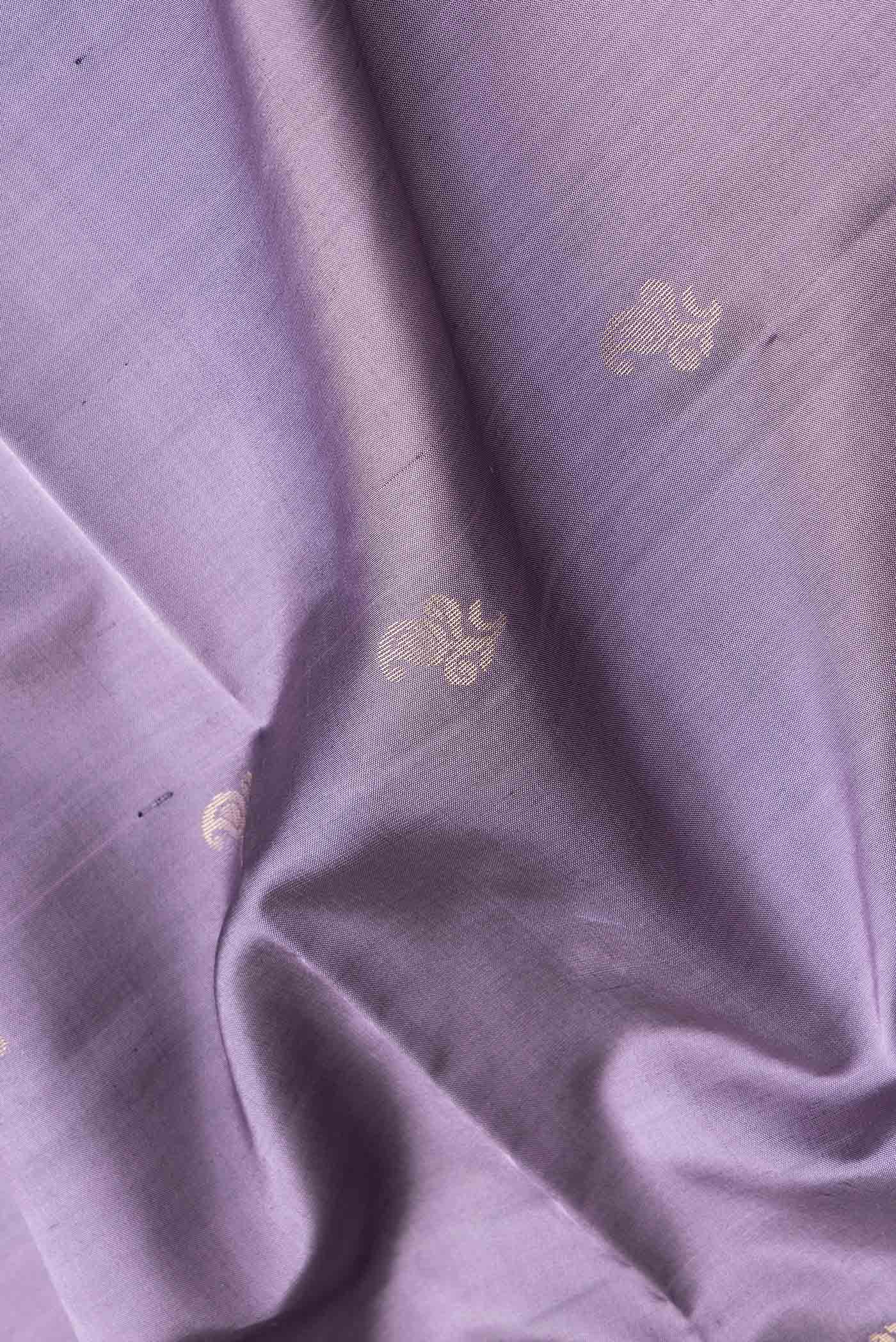 Close up of Purple Dual Tone Soft Silk Saree with Zari Butta on the body and Zari Border.  displaying folds