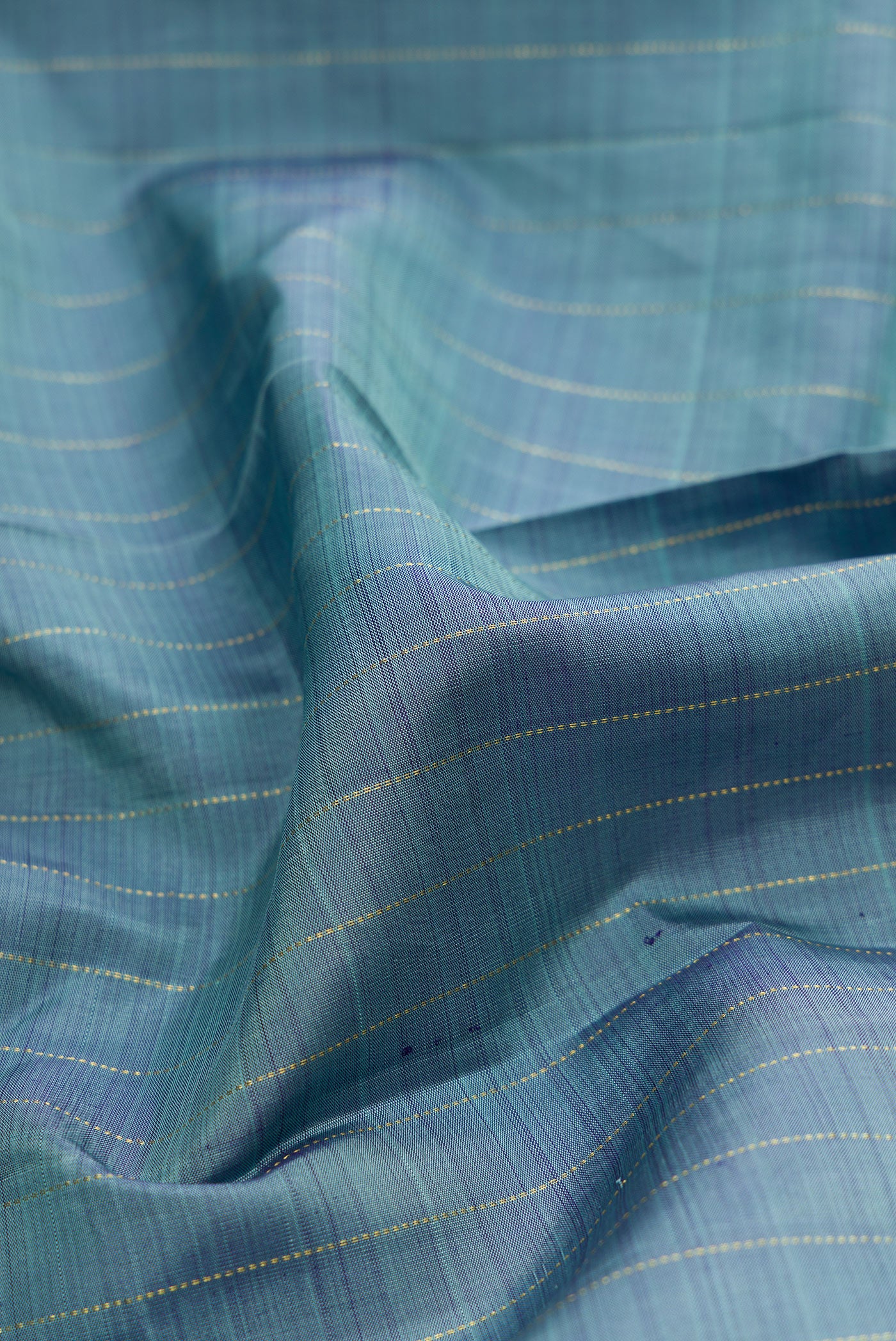 Close up of Blue Grey Kanjivaram Silk Saree with Stripes on the body and Without Border.  displaying folds