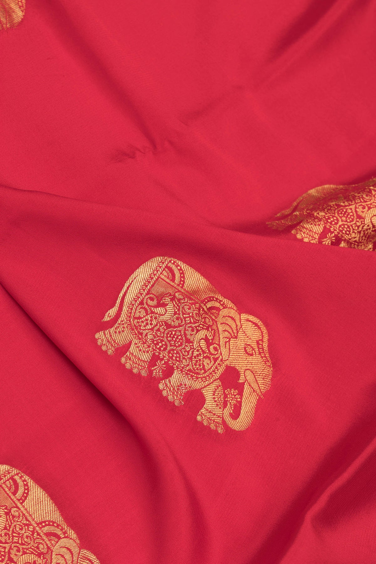 Close up of Red Dual Tone Mysore Silk Saree with Zari Butta on the body and Zari Border.  displaying folds