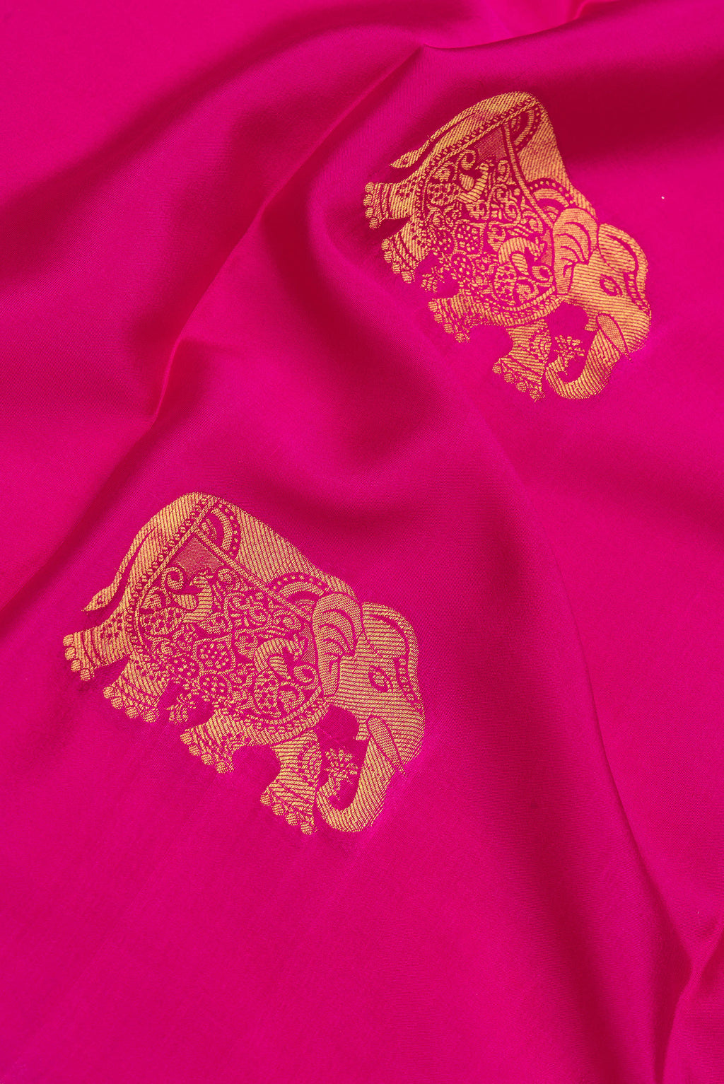 Close up of Dark Pink Mysore Silk Saree with Zari Butta on the body and Zari Border.  displaying folds