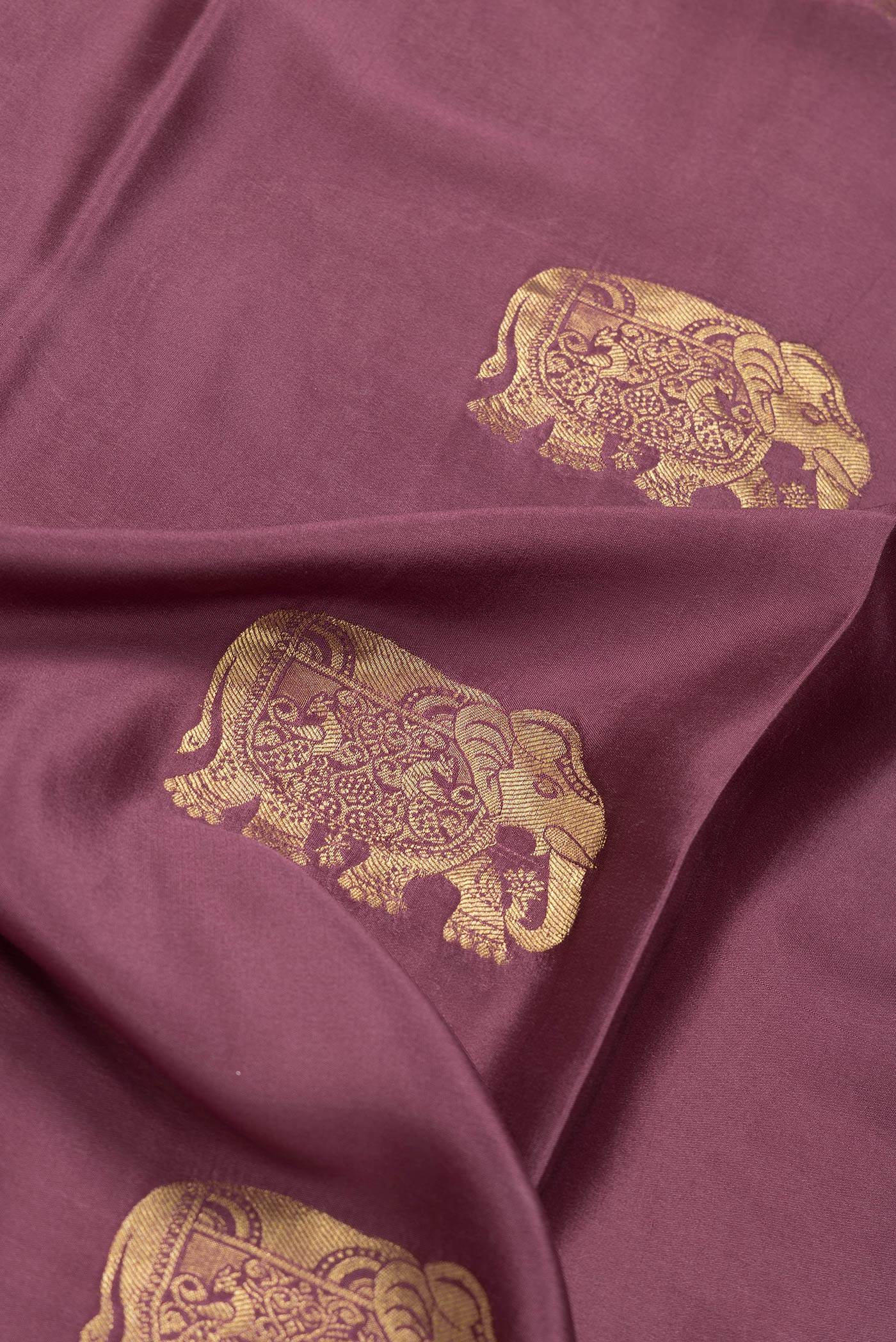 Close up of Burgundy Dual Tone Mysore Silk Saree with Zari Butta on the body and Zari Border.  displaying folds