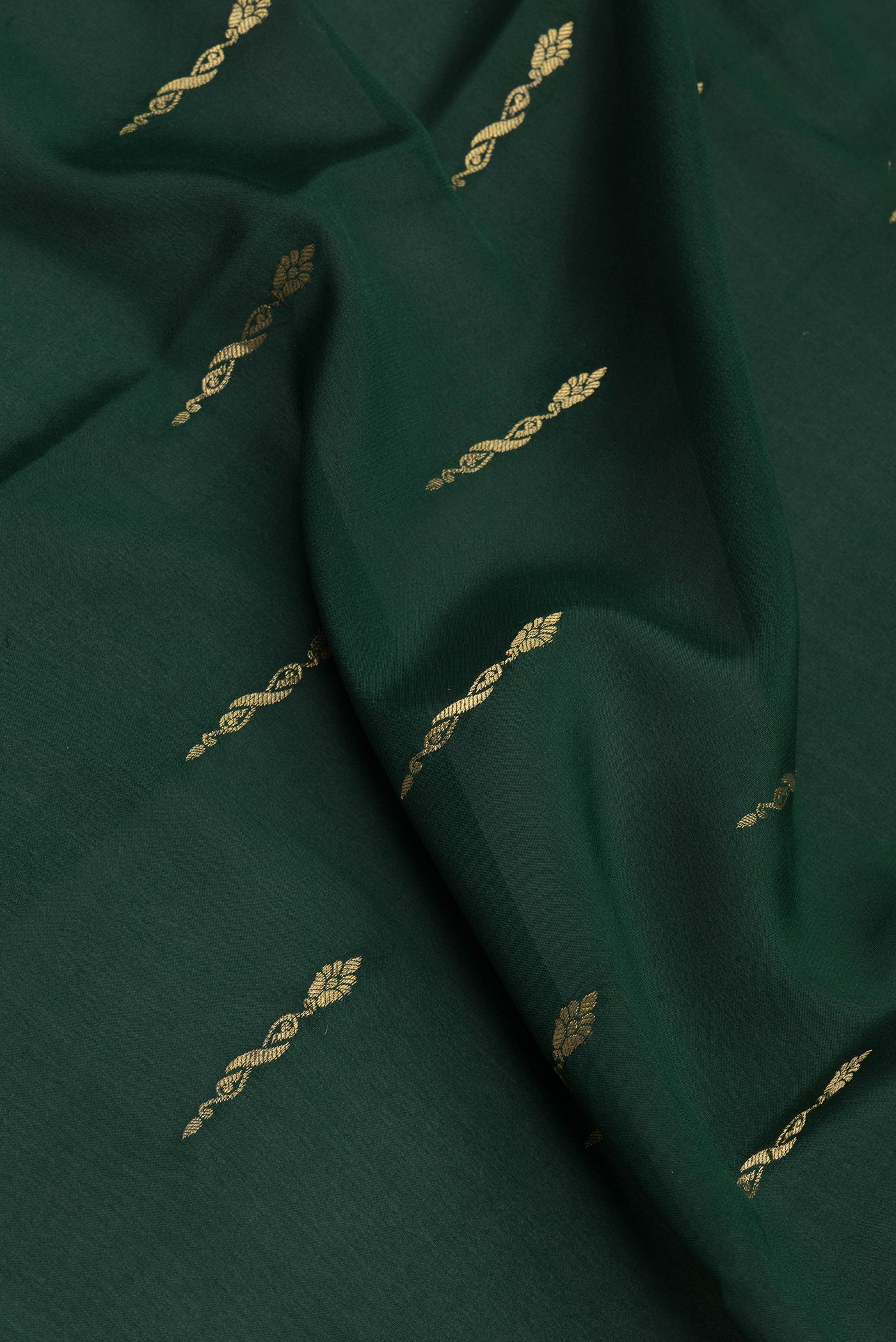Close up of Bottle Green Mysore Silk Saree with Zari Butta on the body and Zari Border.  displaying folds