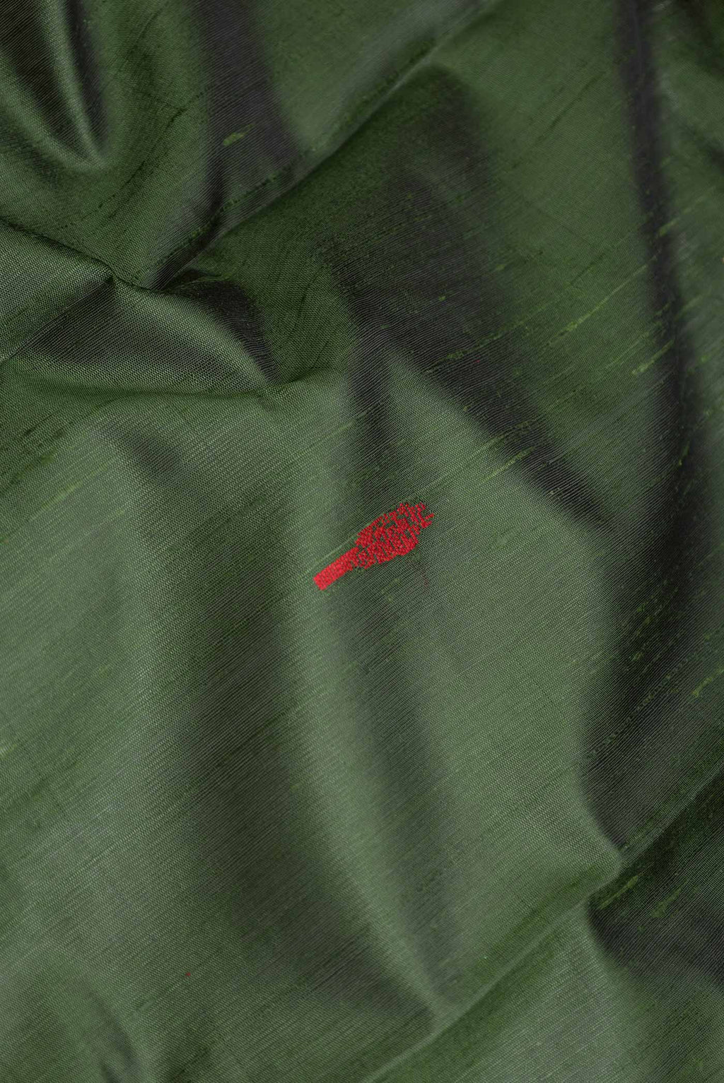 Close up of Green Dual Tone Tussar Saree with Plain Body and Zari Border displaying folds