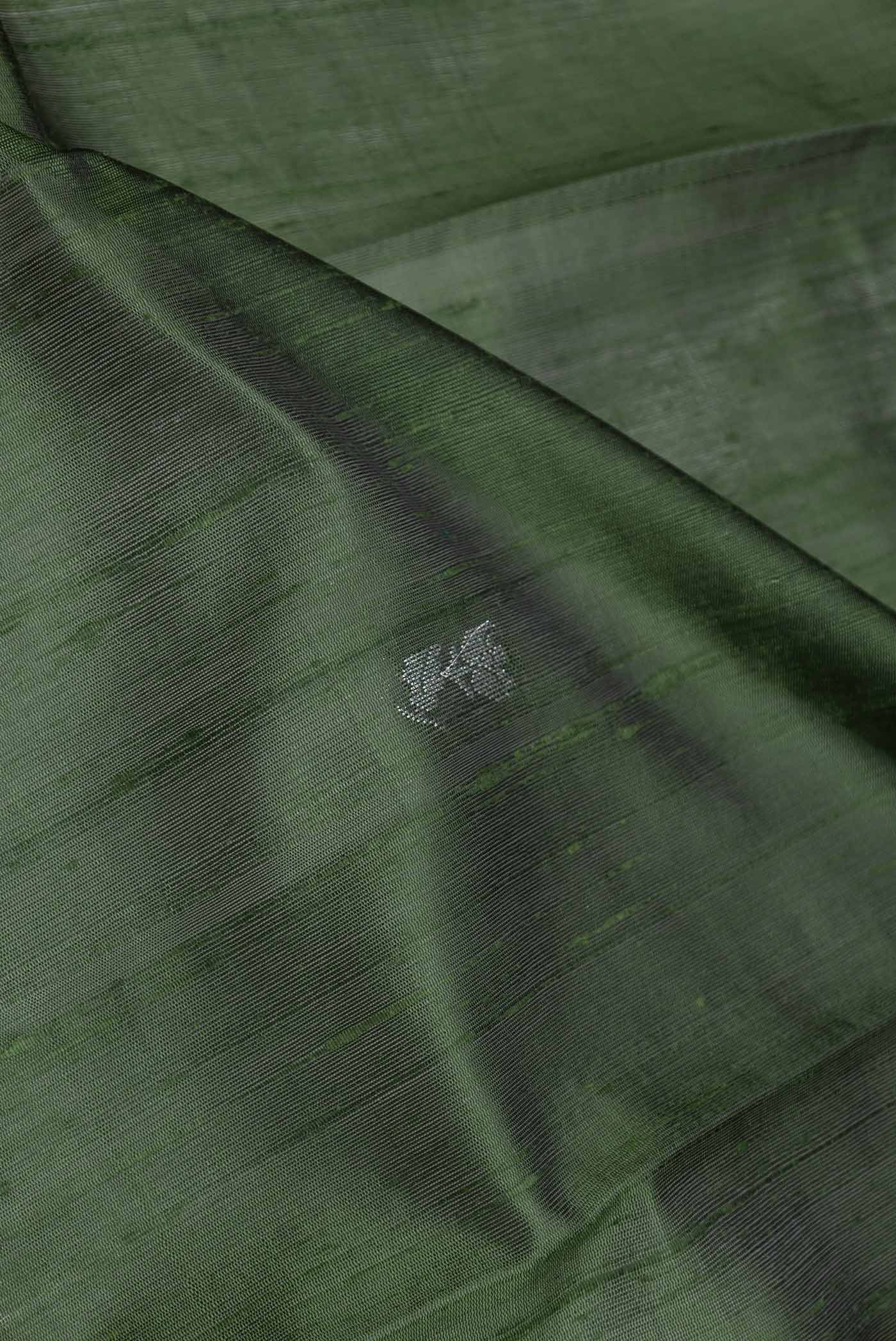 Close up of Green Dual Tone Tussar Silk Saree with Thread Butta on the body and Fancy Border displaying folds