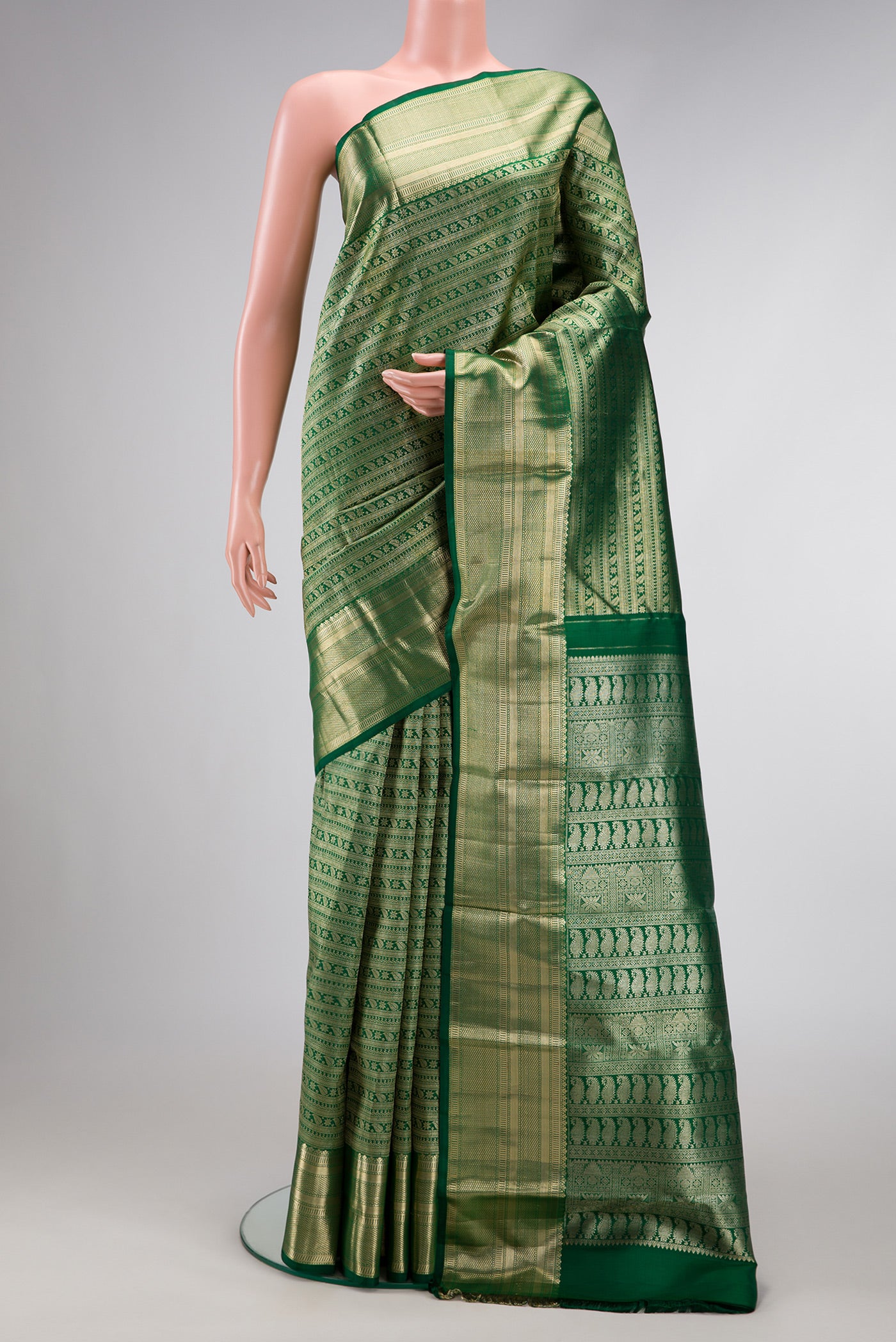 Green Dual Tone Kanchipuram Silk Saree with Zari Brocade on the body and Zari Border.  displayed on a mannequin