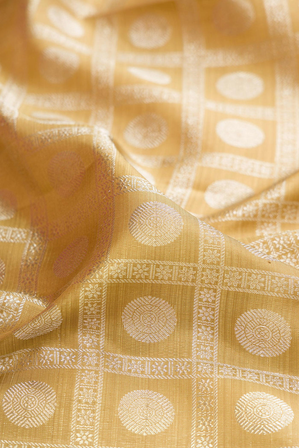 Close up of Sandal Kanchipuram Silk Saree with Zari Brocade on the body and Zari Border.  displaying folds