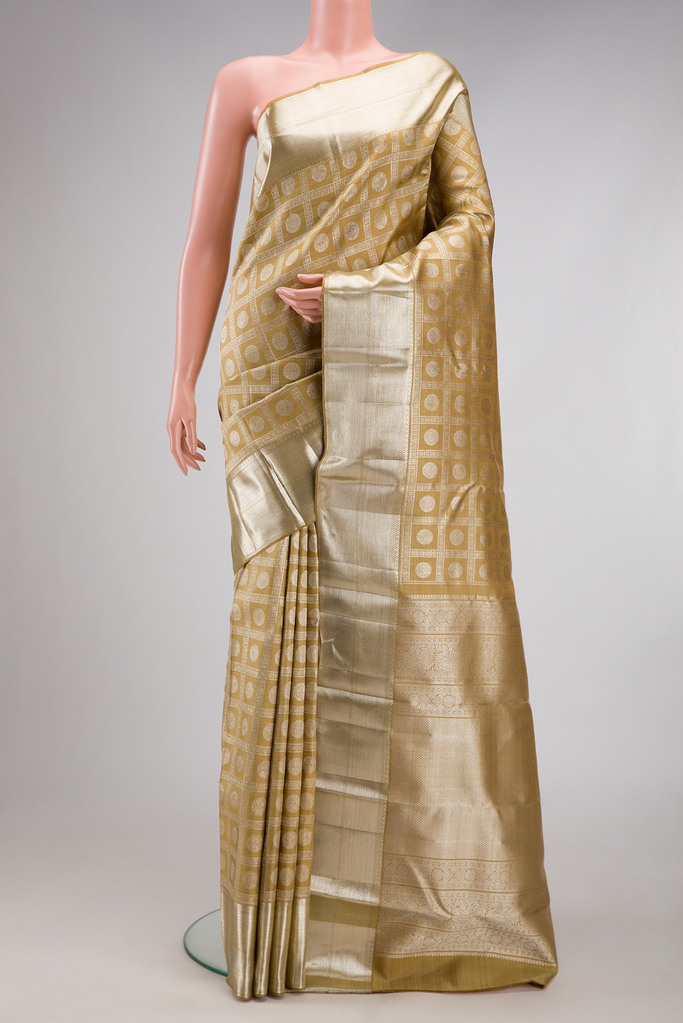 Sandal Kanchipuram Silk Saree with Zari Brocade on the body and Zari Border.  displayed on a mannequin