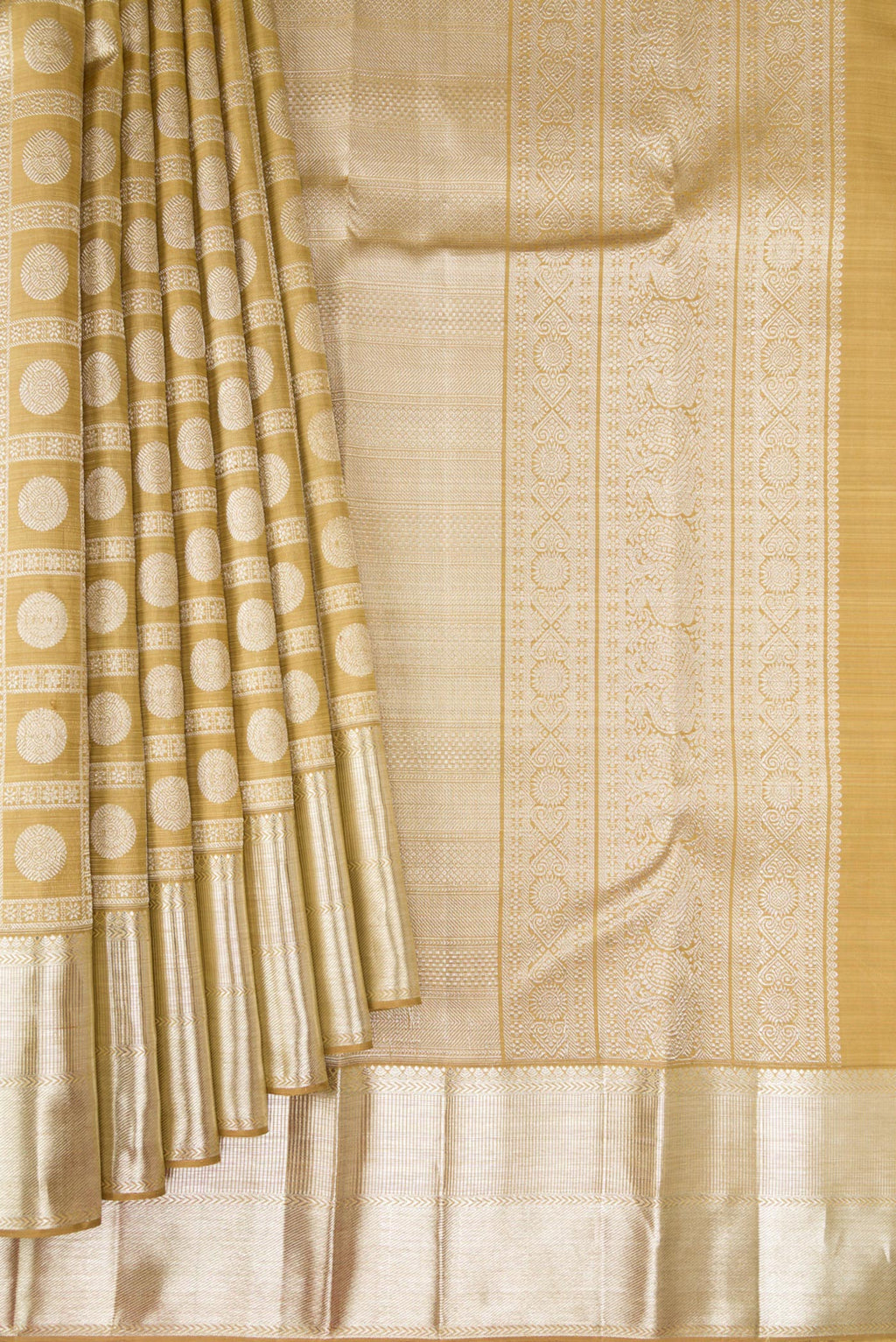 Pleats and pallu of Sandal Kanchipuram Silk Saree with Zari Brocade on the body and Zari Border. 
