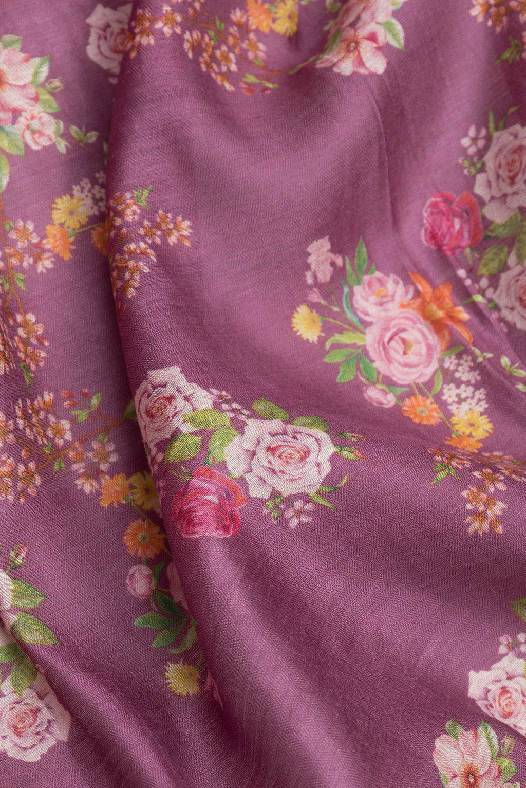 Close up of Purple Dual Tone Tussar Silk Saree with Floral Print on the body and Zari Border.  displaying folds