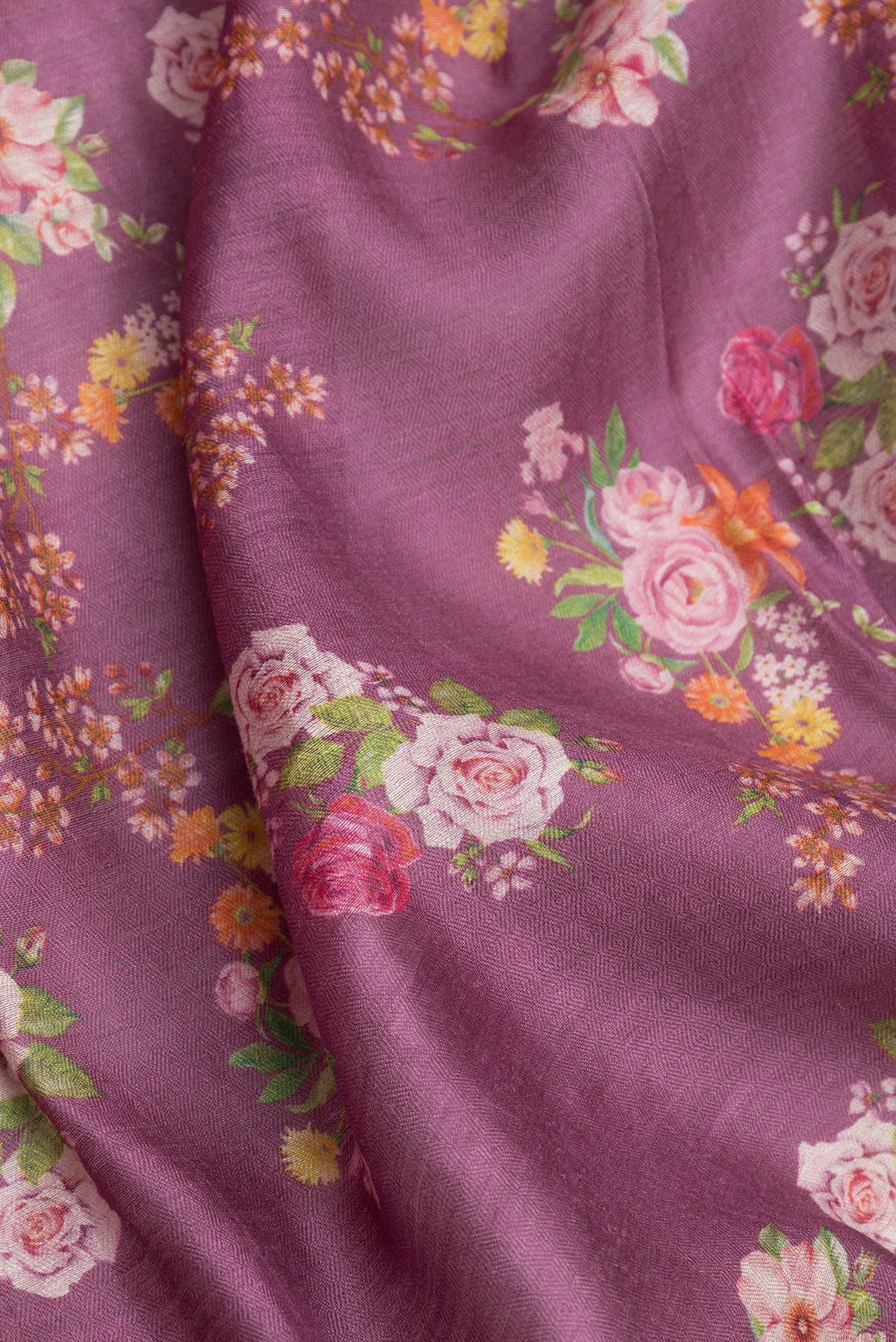Close up of Purple Dual Tone Tussar Silk Saree with Floral Print on the body and Zari Border.  displaying folds