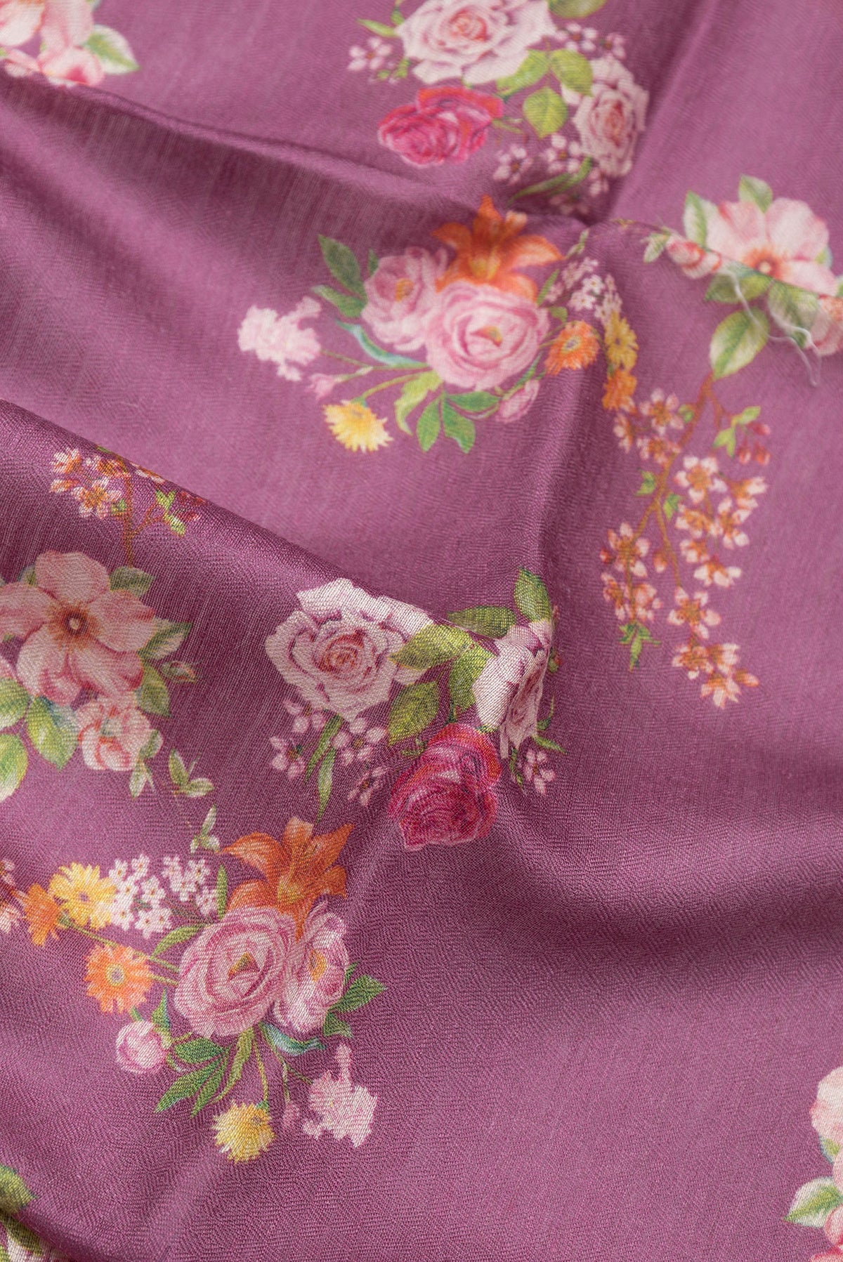 Close up of Purple Tussar Silk Saree with Floral Print on the body and Zari Border.  displaying folds