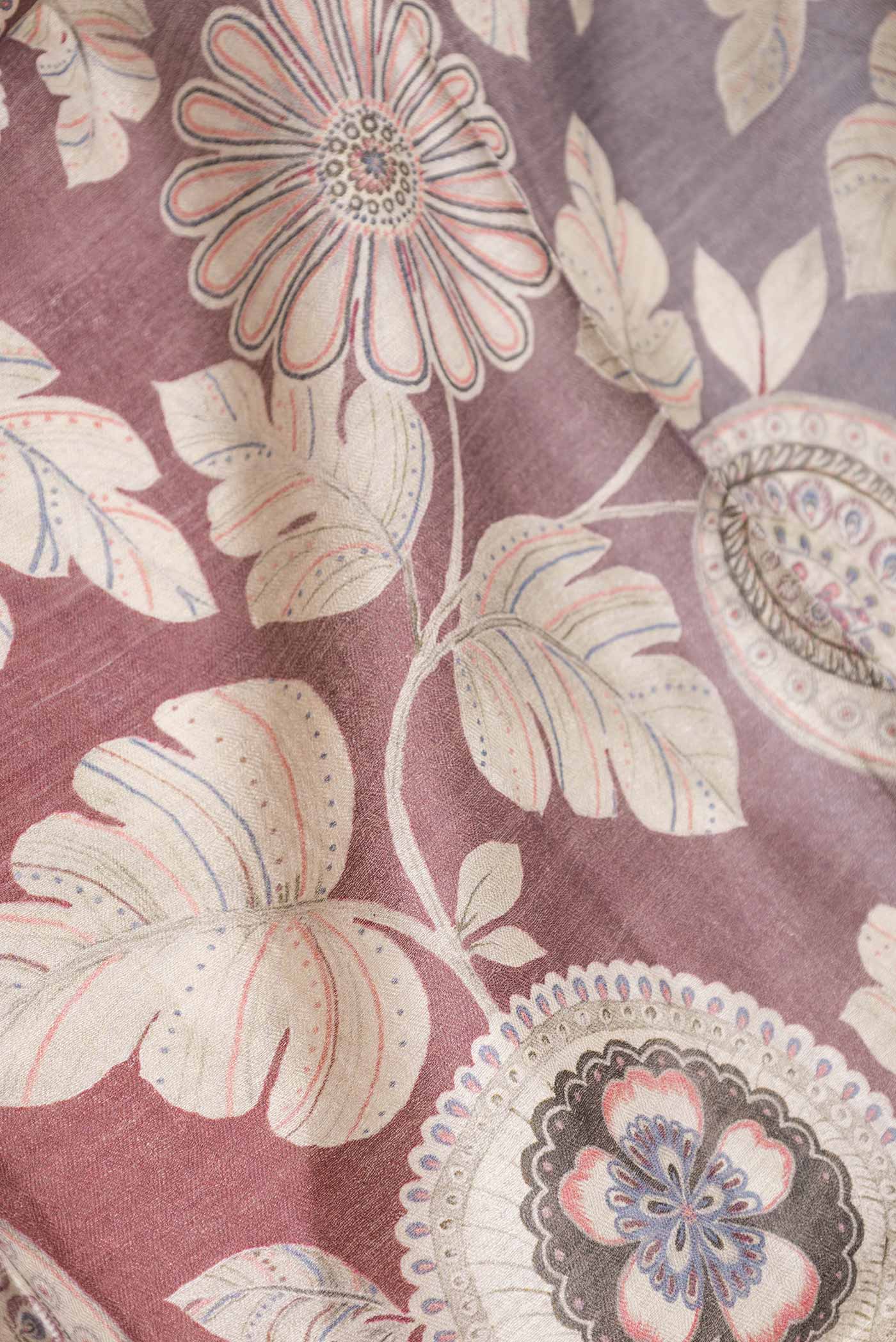 Close up of Maroon Dual Tone Tussar Saree with Printed design on the body and Zari Border displaying folds