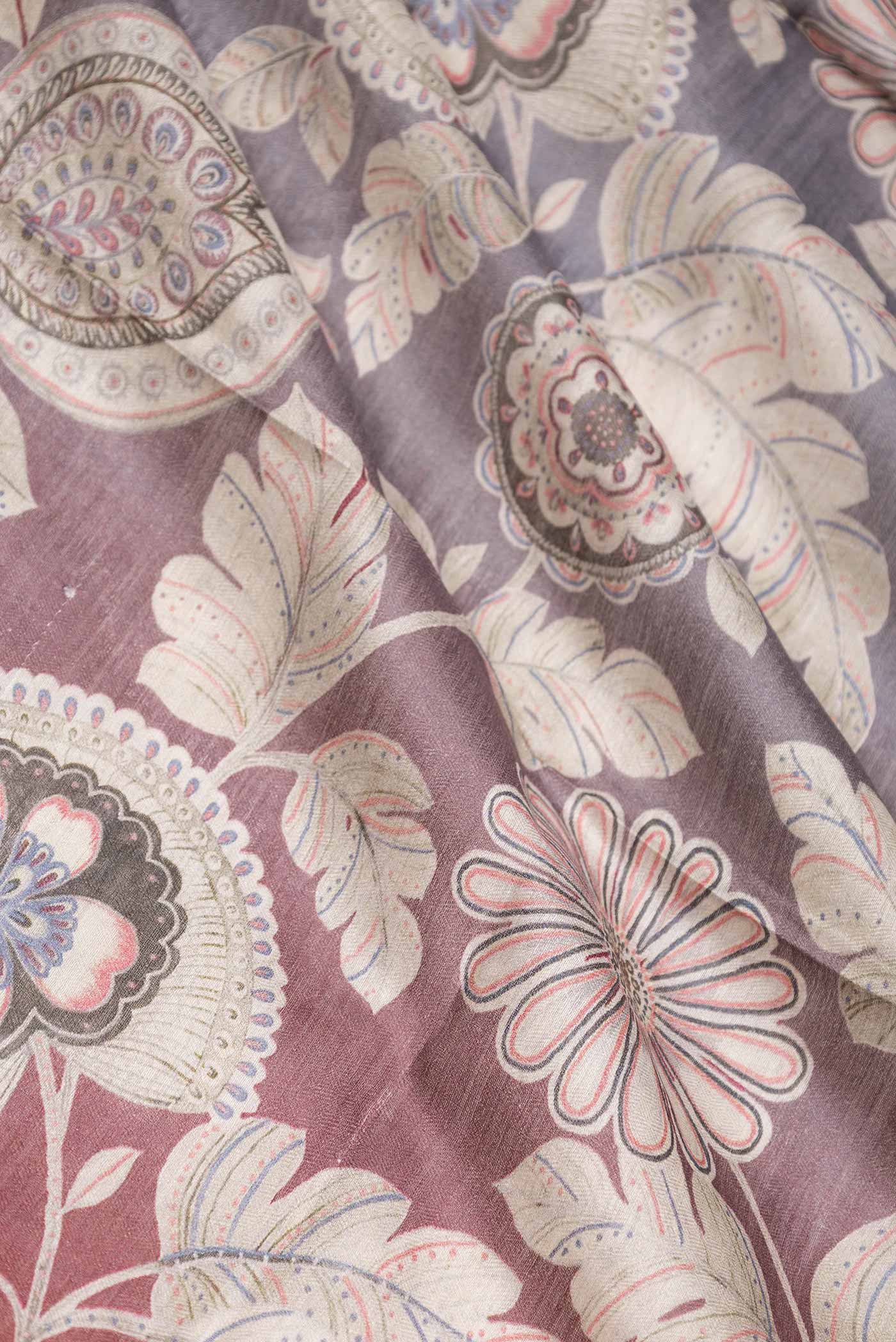 Close up of Maroon Dual Tone Tussar Saree with Printed design on the body and Zari Border displaying folds