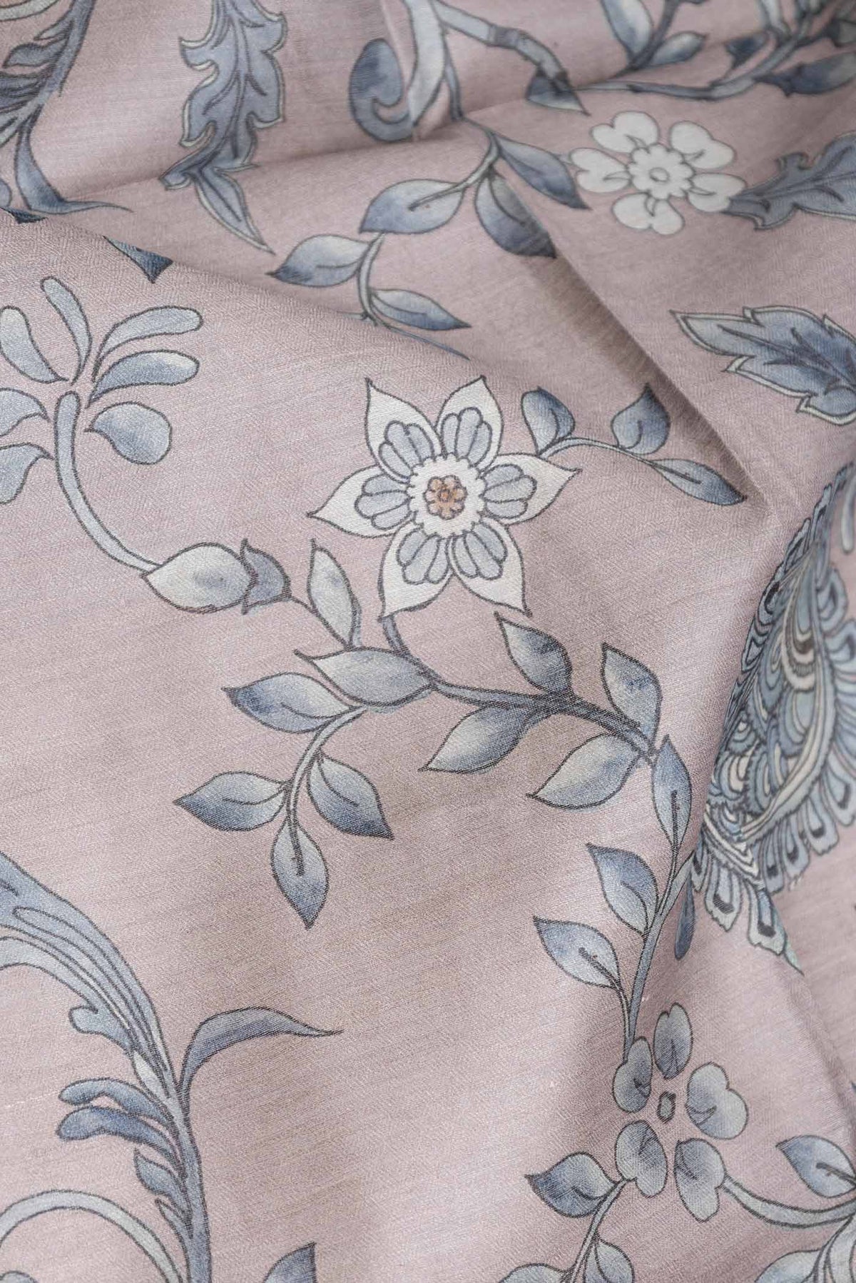 Close up of Grey Dual Tone Tussar Saree with Printed design on the body and Zari Border displaying folds