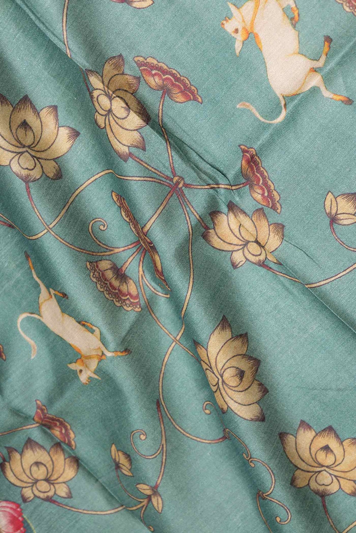 Close up of Green Dual Tone Tussar Saree with Printed design on the body and Zari Border displaying folds