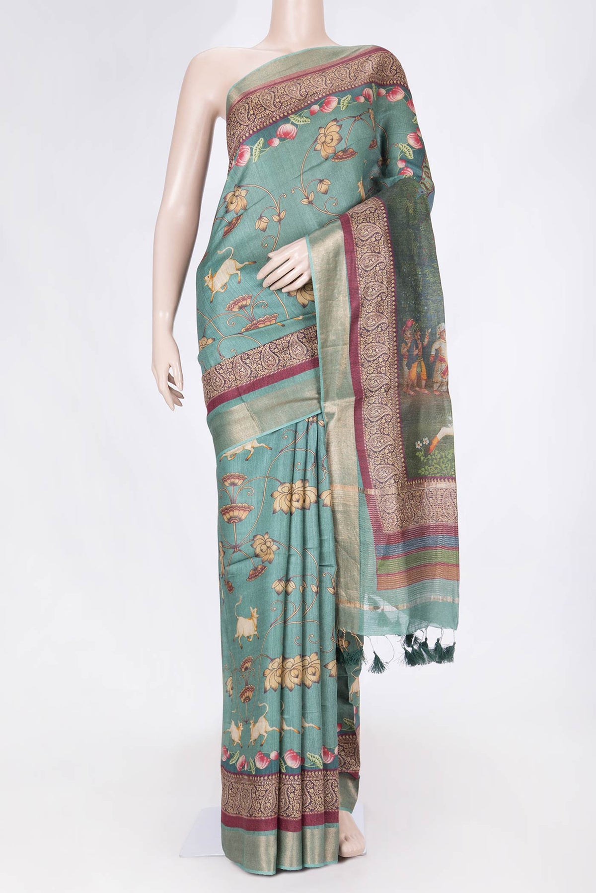 Green Dual Tone Tussar Saree with Printed design on the body and Zari Border displayed on a mannequin