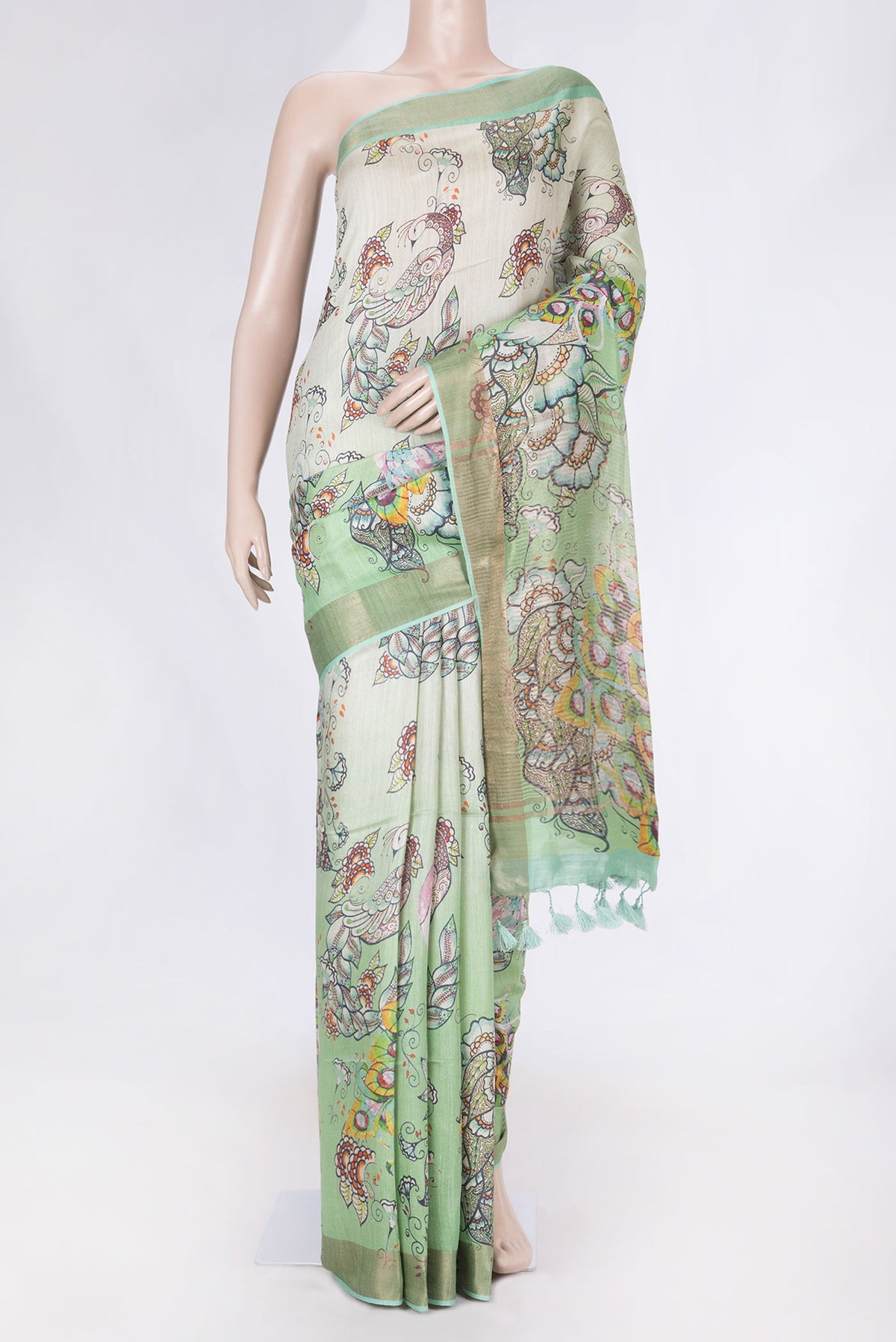Green Dual Tone Tussar Saree with Printed design on the body and Zari Border displayed on a mannequin