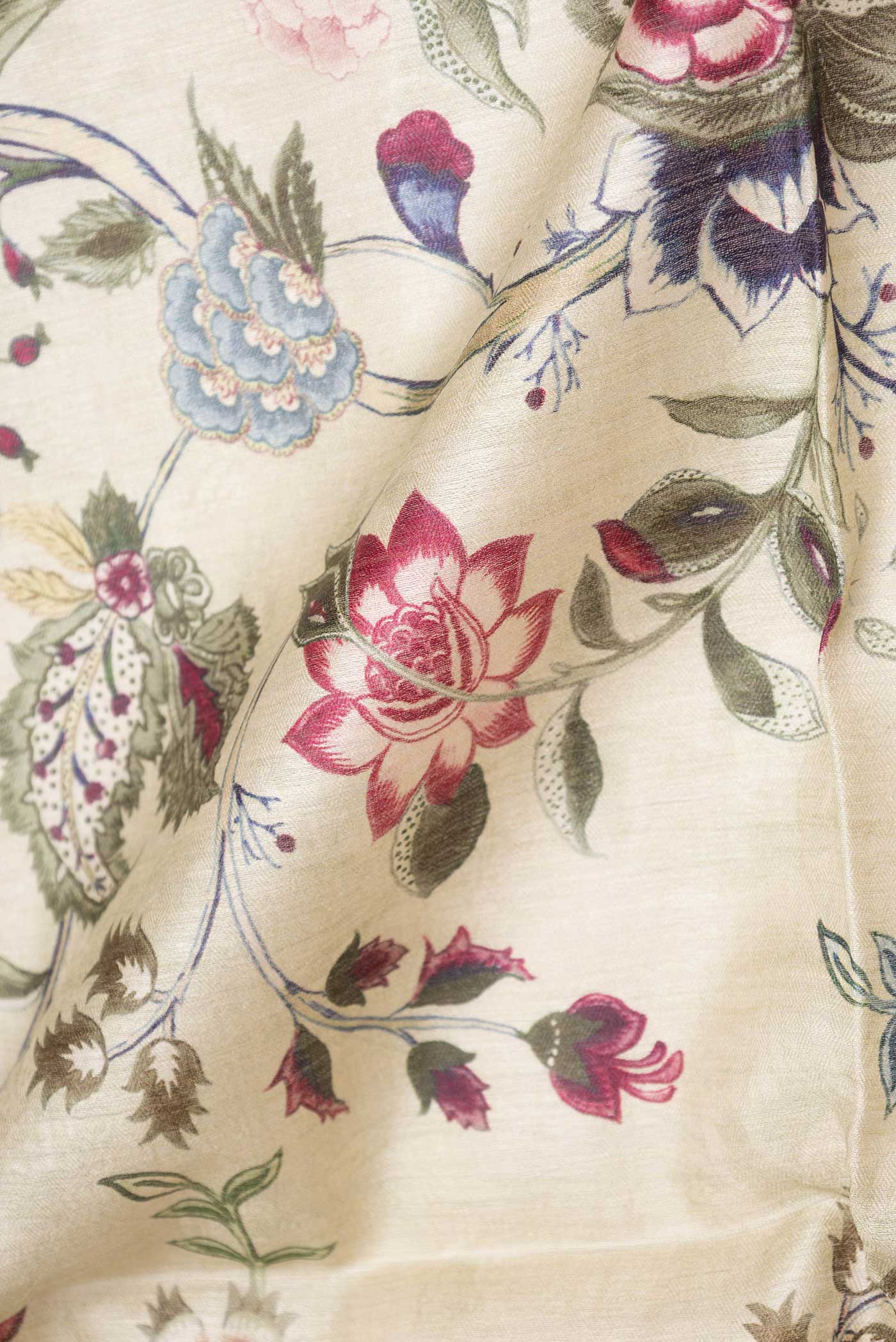 Close up of Beige Dual Tone Tussar Saree with Printed design on the body and Zari Border displaying folds