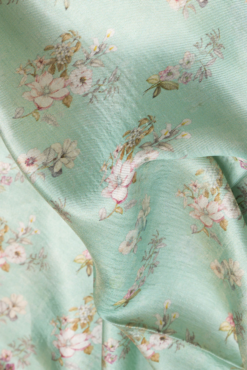 Close up of Sea Green Dual Tone Tussar Silk Saree with Printed design on the body and Zari Border.  displaying folds