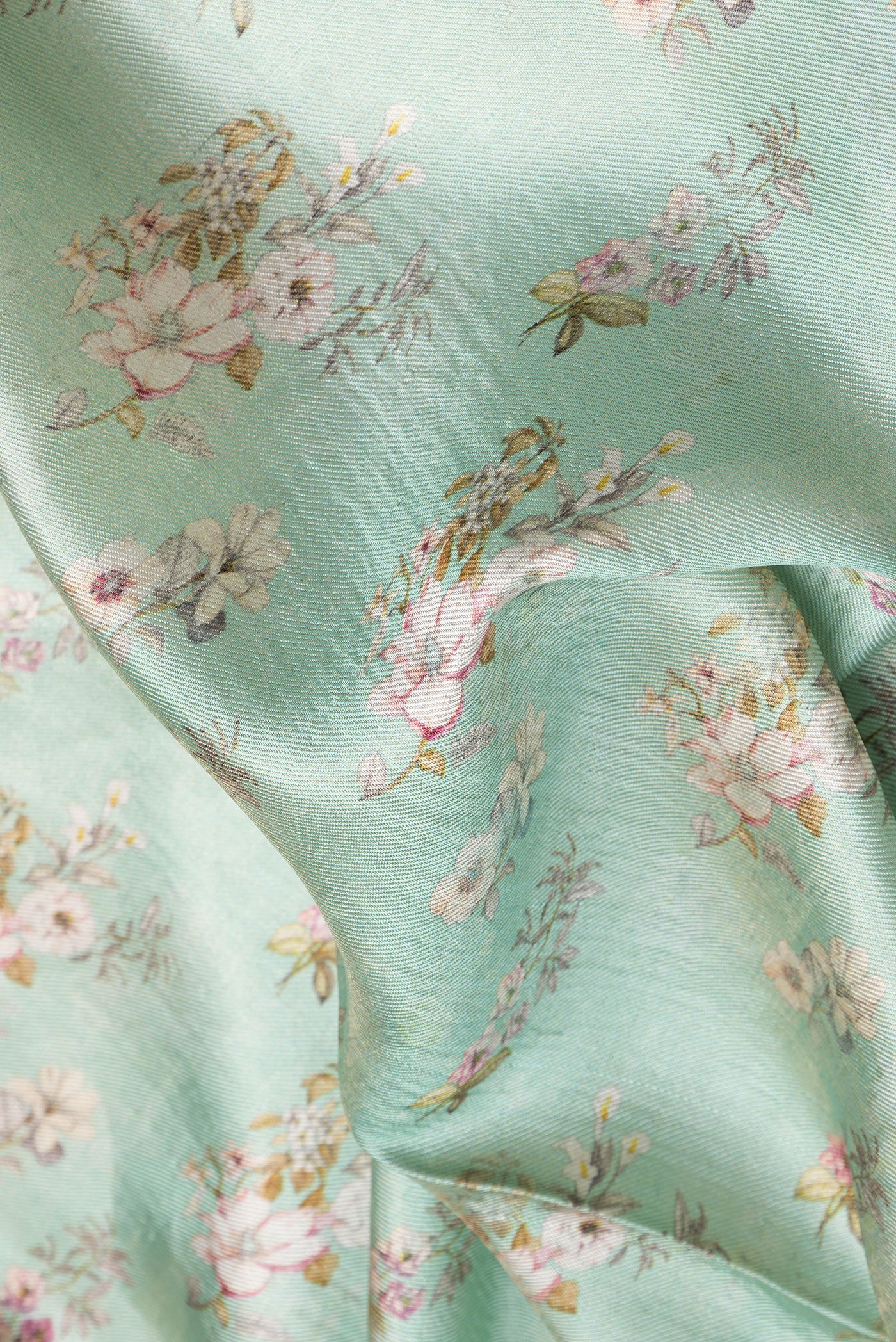 Close up of Sea Green Dual Tone Tussar Silk Saree with Printed design on the body and Zari Border.  displaying folds