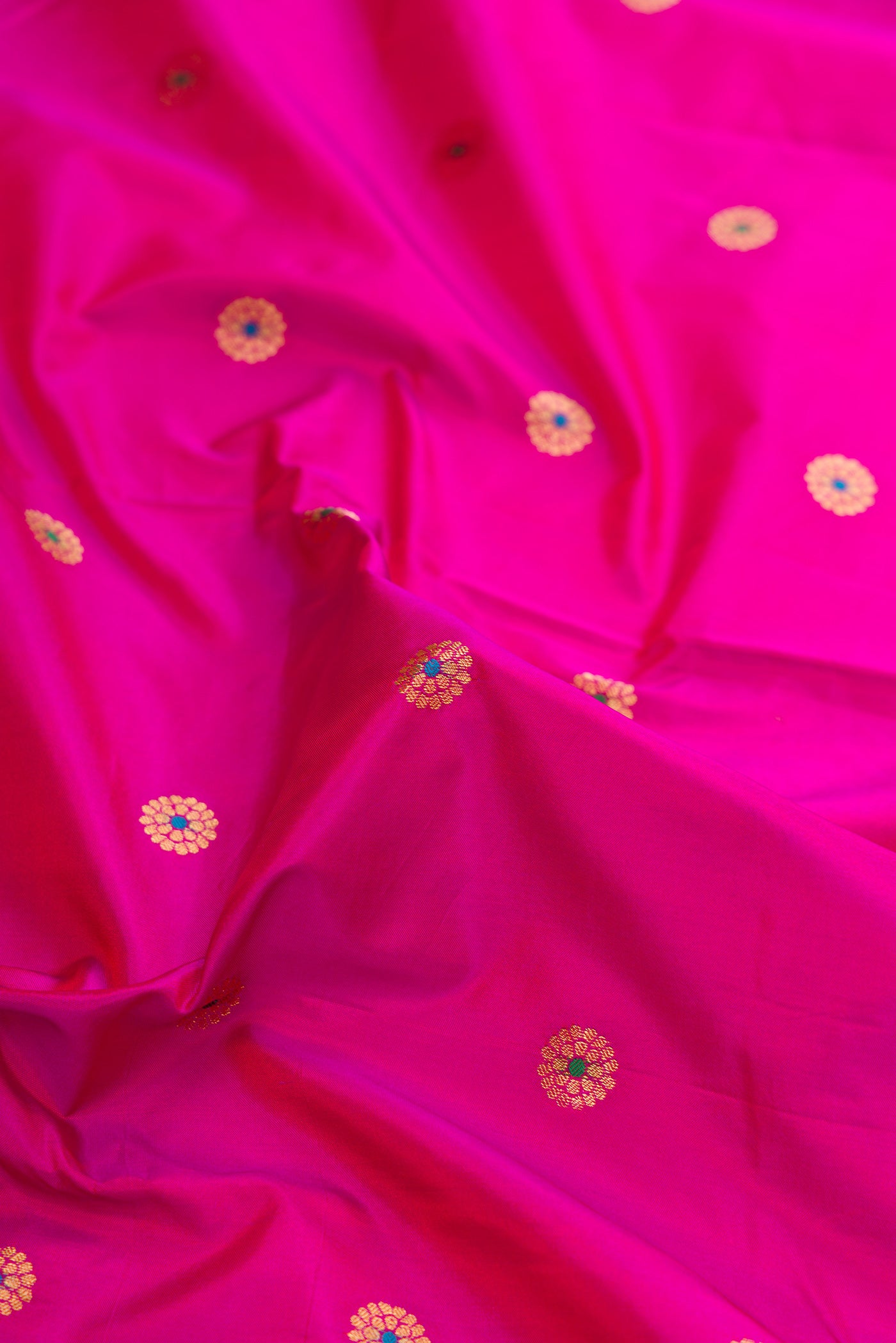 Close up of Pink Dual Tone Paithani Silk Saree with Zari And Thread Butta on the body and Zari Border.  displaying folds