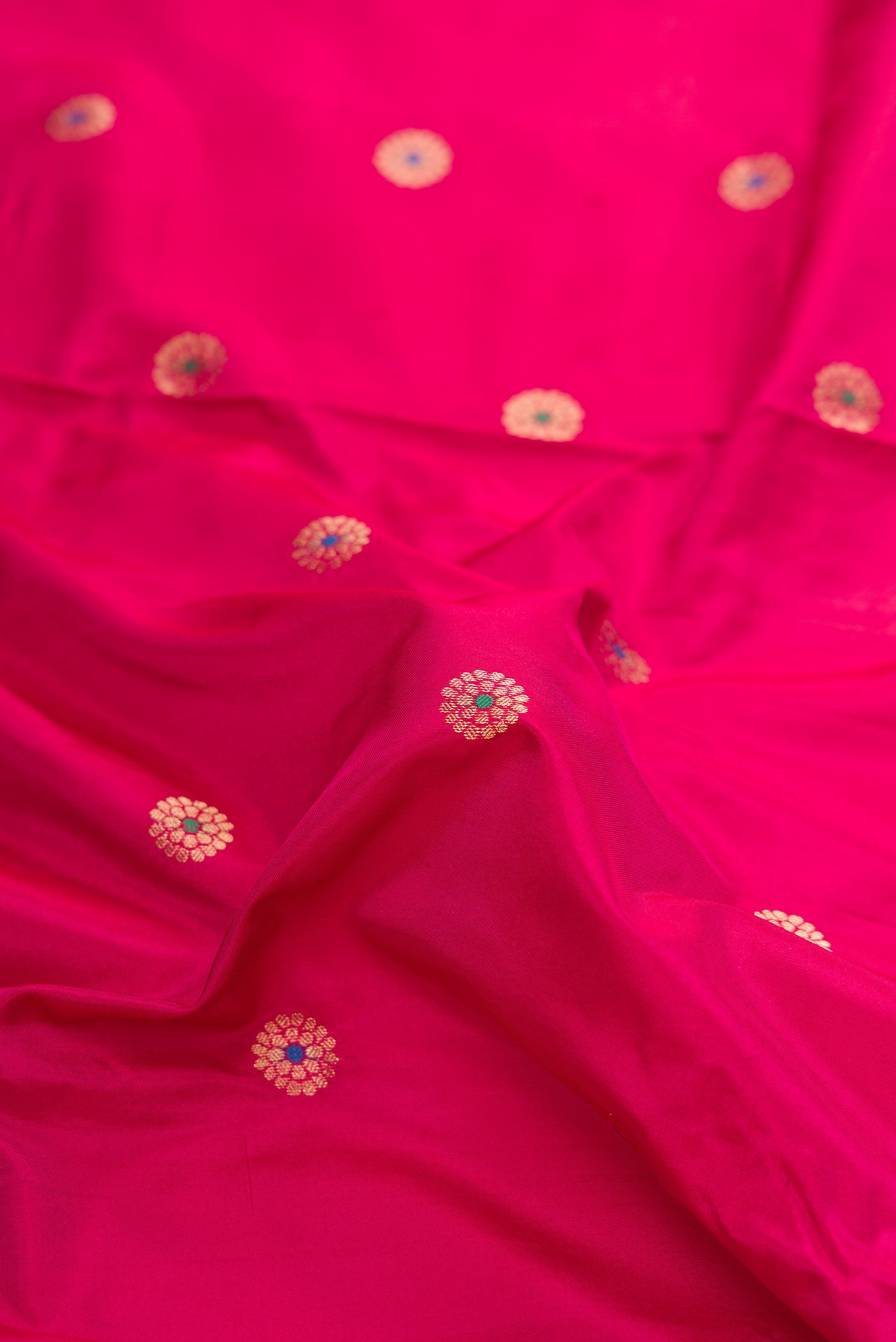 Close up of Dark Mauve Dual Tone Paithani Silk Saree with Zari And Thread Butta on the body and Zari Border.  displaying folds