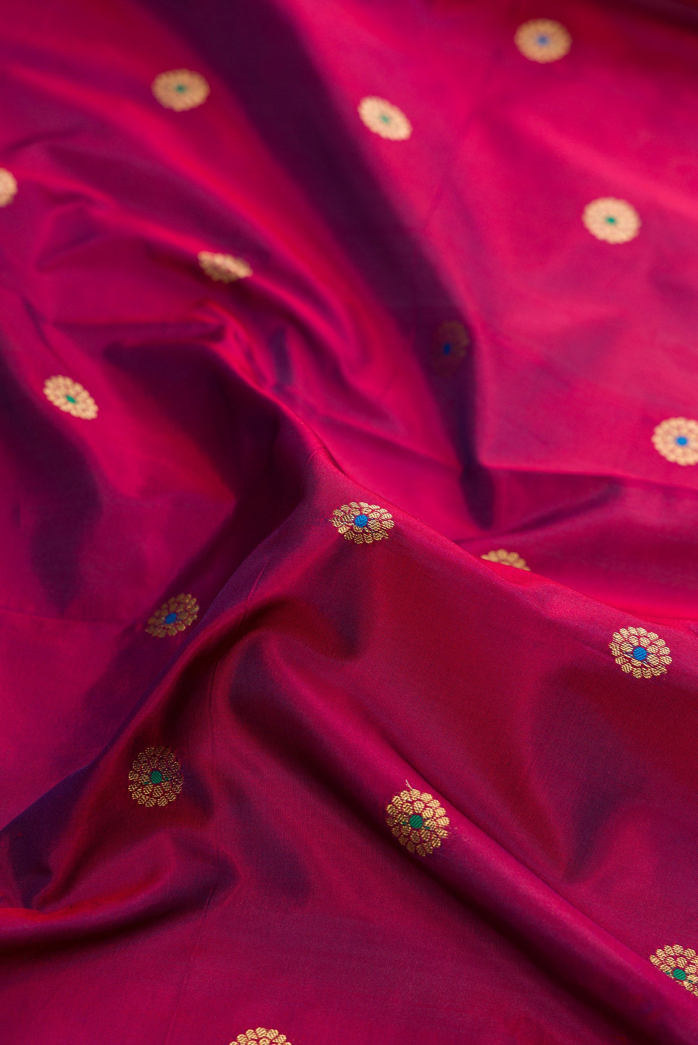 Close up of Maroon Dual Tone Paithani Silk Saree with Zari And Thread Butta on the body and Zari Border.  displaying folds
