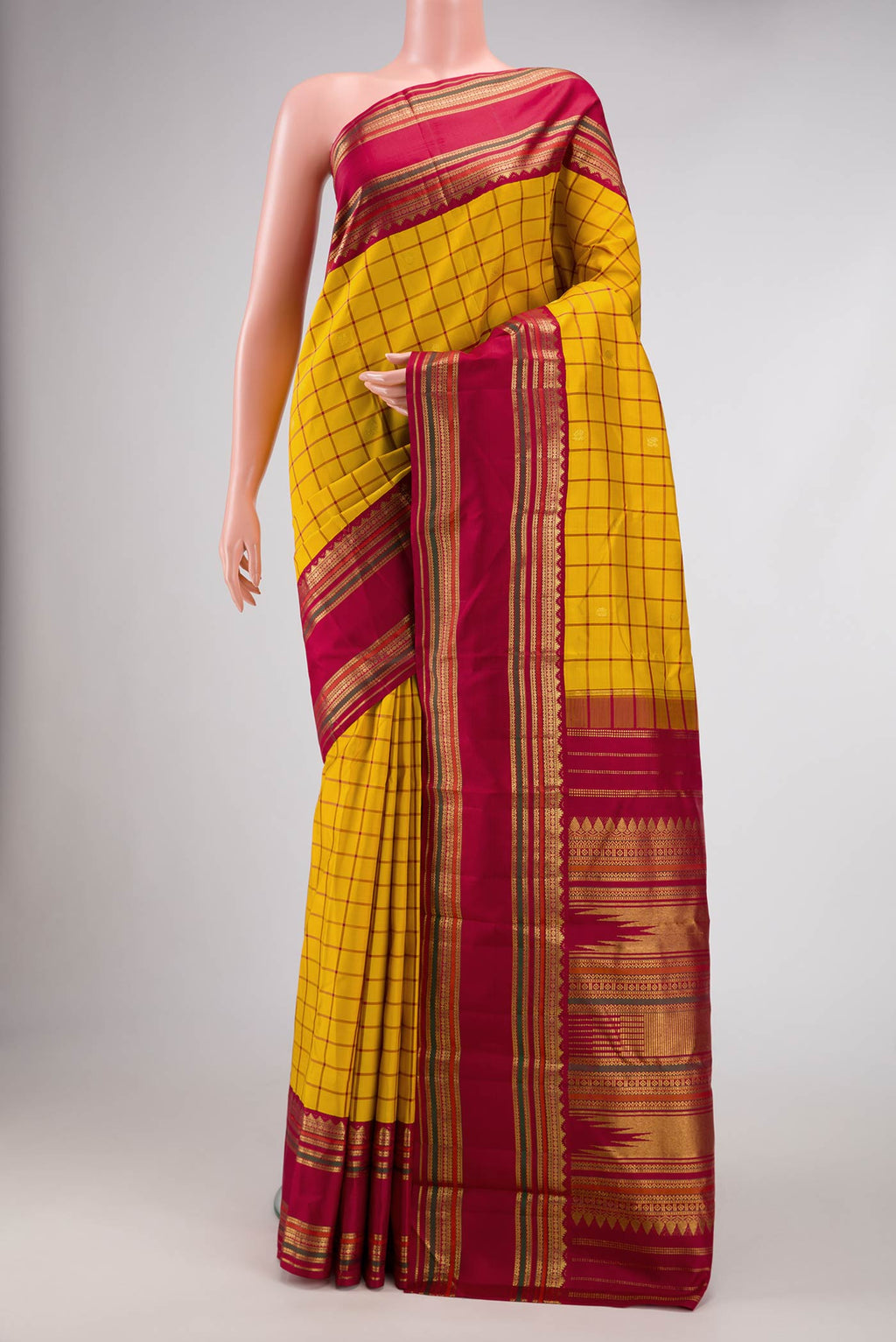 Yellow Dual Tone Kanjivaram Silk Saree with Checked design on the body and Zari Border.  displayed on a mannequin