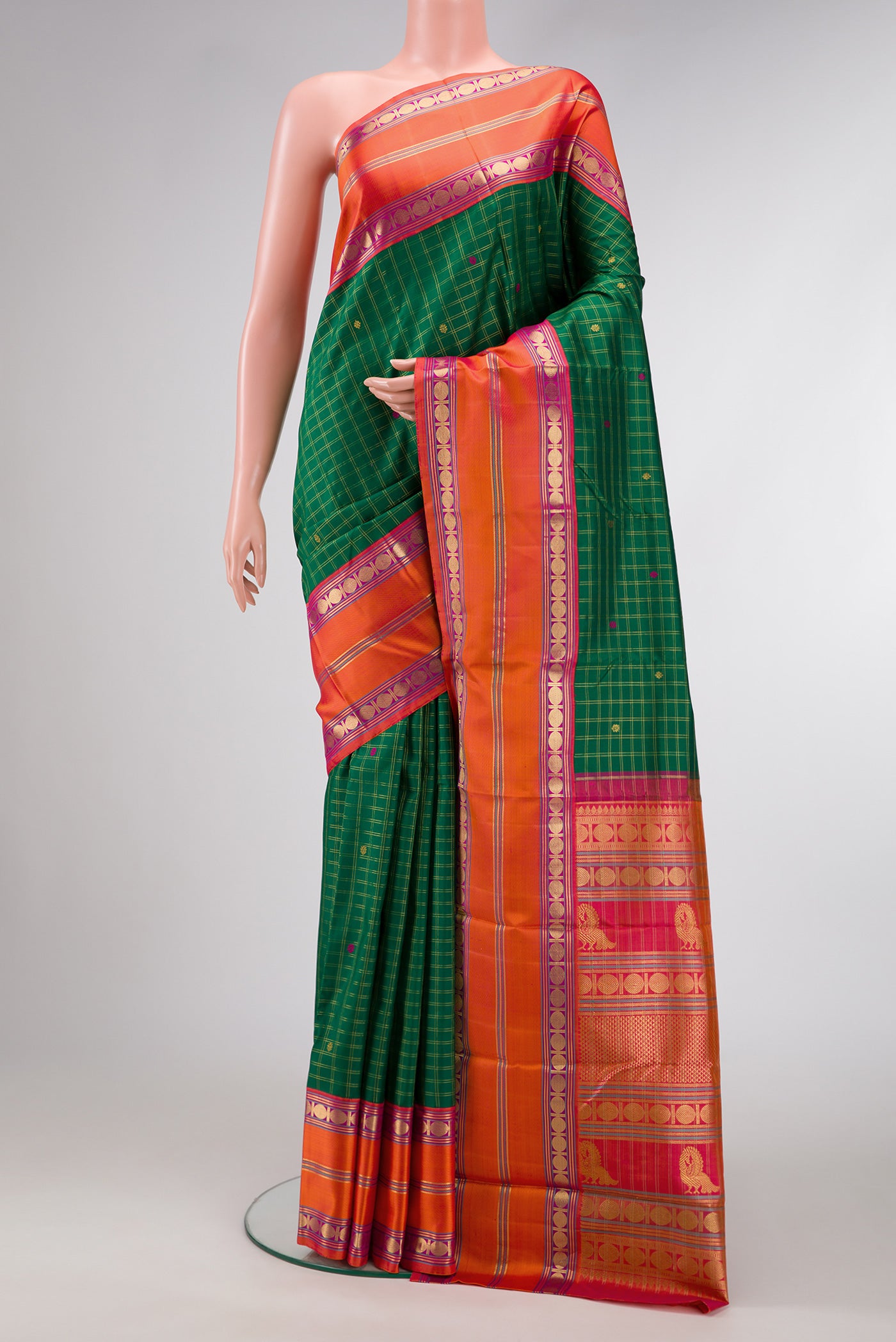 Green Dual Tone Kanjivaram Silk Saree with Checked design on the body and Zari Border.  displayed on a mannequin