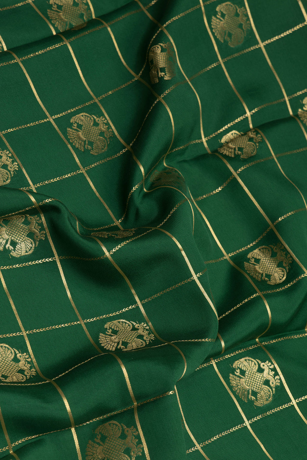 Close up of Green Mysore Silk Saree with Checked design on the body and Zari Border.  displaying folds