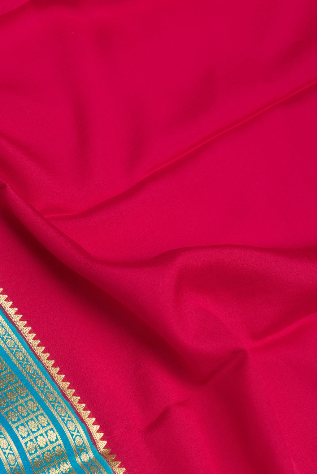 Close up of Pink Mysore Silk Saree with Plain Body and Zari Border.  displaying folds