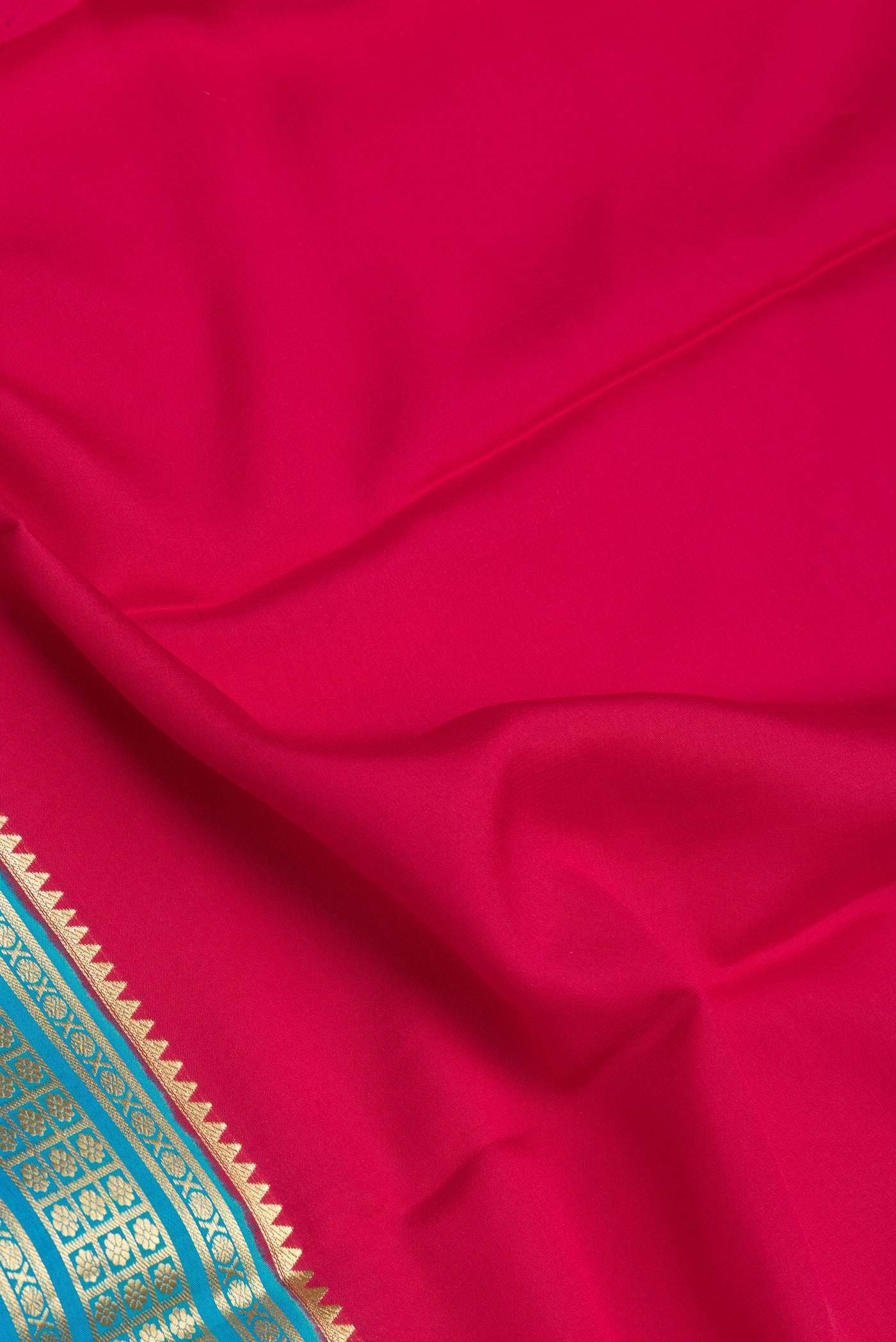 Close up of Pink Mysore Silk Saree with Plain Body and Zari Border.  displaying folds