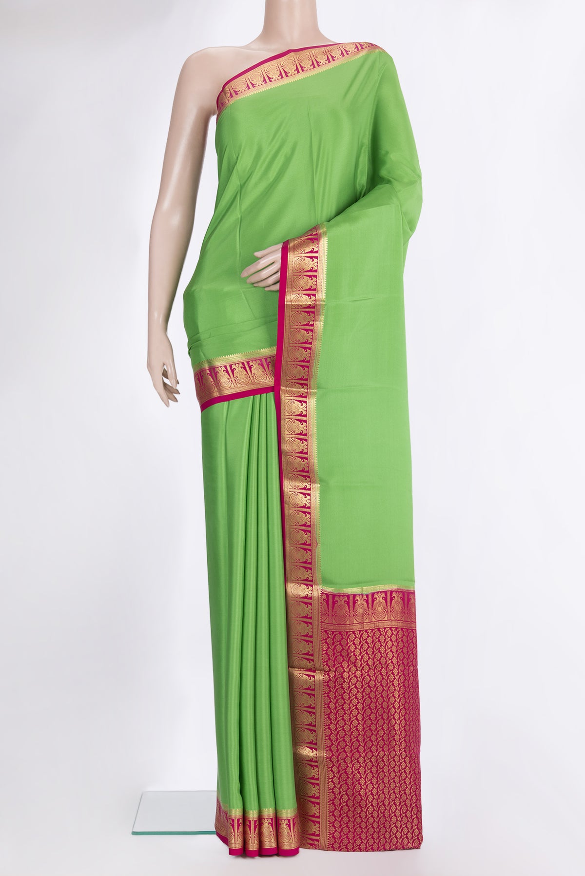 Parrot Green Mysore Crepe Saree with Plain Body and Zari Border.  displayed on a mannequin