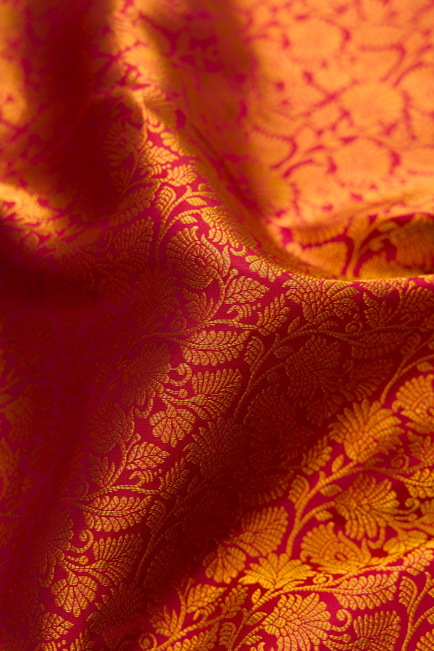 Close up of Maroon Kanjivaram Silk Saree with Zari Brocade on the body and Zari Border.  displaying folds