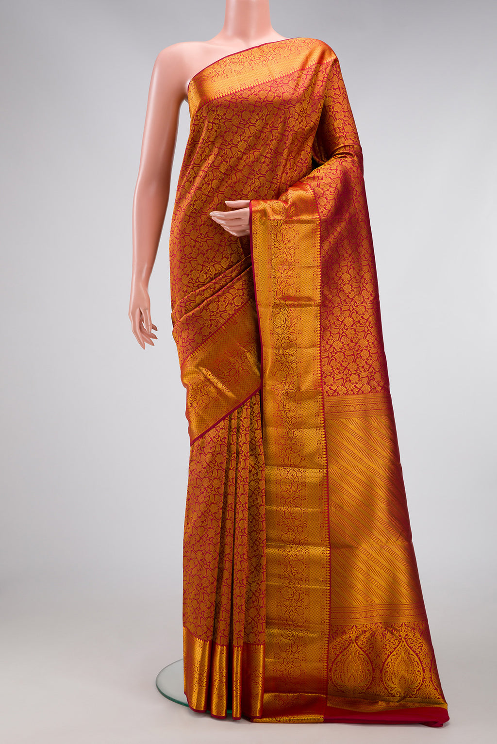 Maroon Kanjivaram Silk Saree with Zari Brocade on the body and Zari Border.  displayed on a mannequin