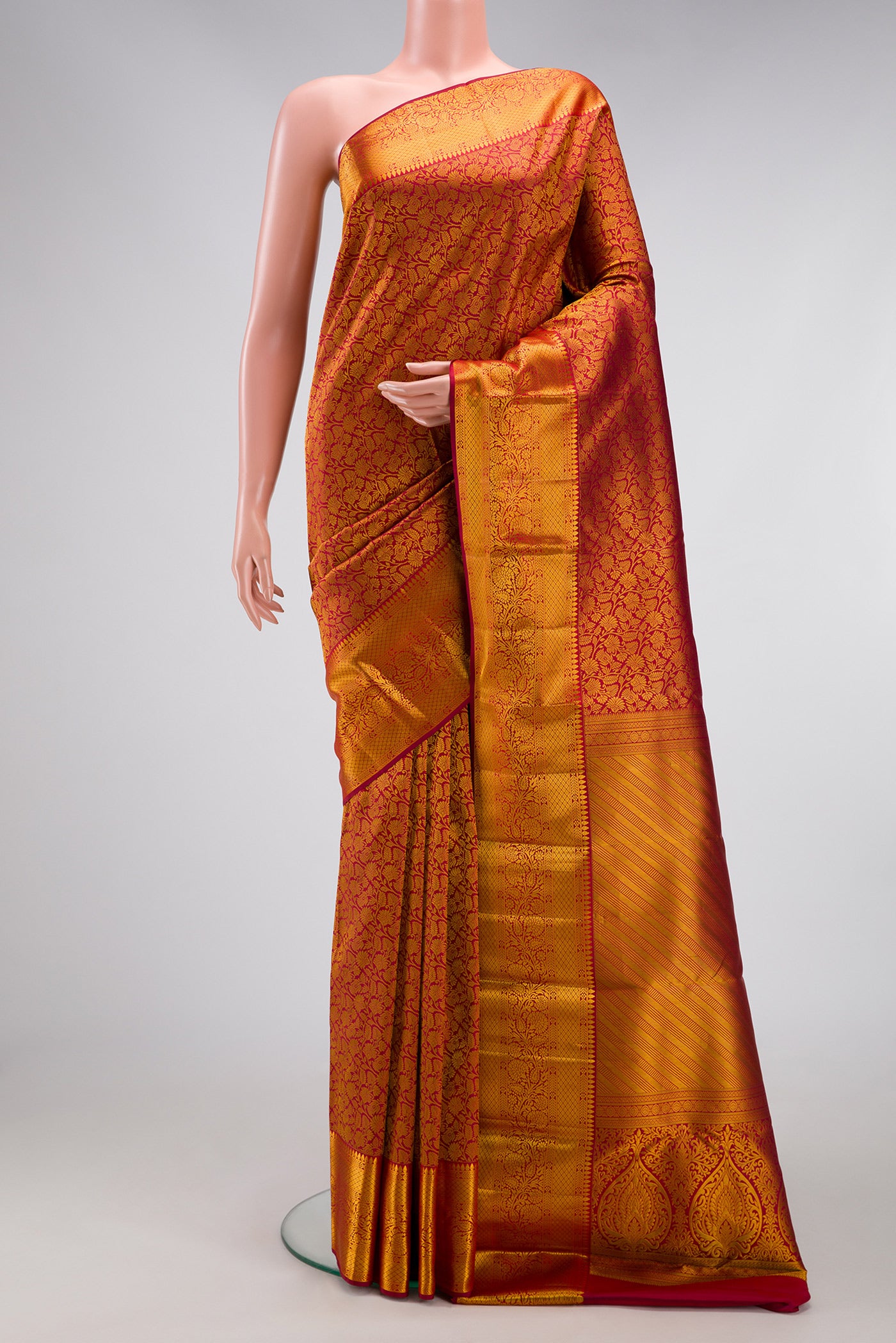 Maroon Kanjivaram Silk Saree with Zari Brocade on the body and Zari Border.  displayed on a mannequin