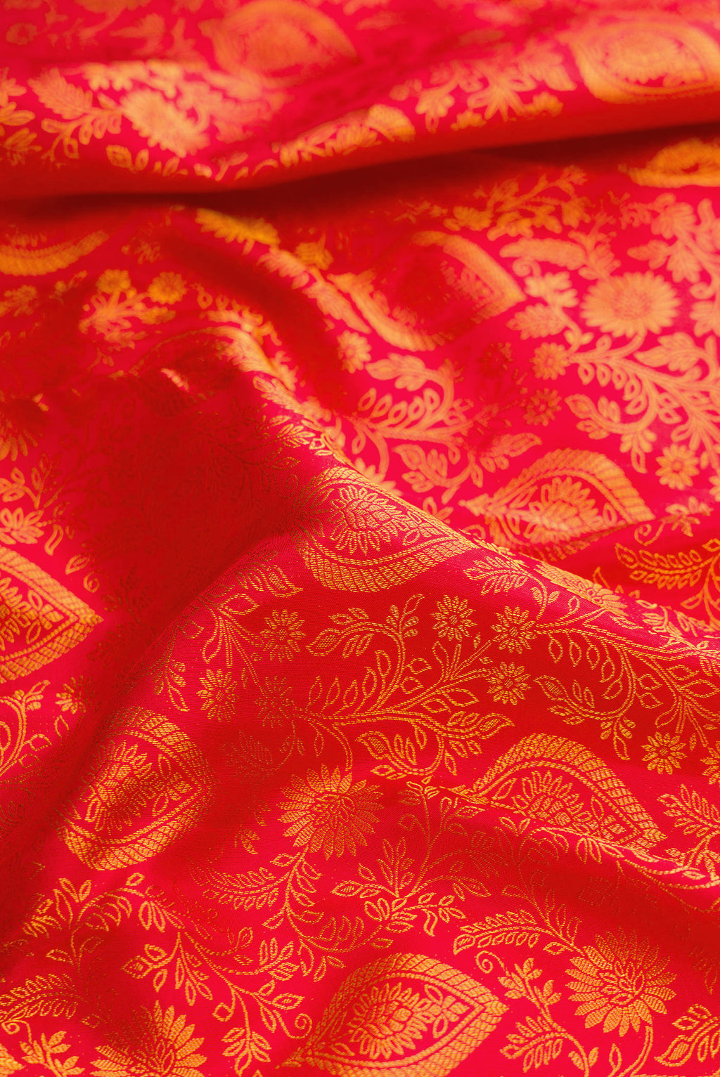 Close up of Red Dual Tone Kanjivaram Silk Saree with Zari Brocade on the body and Zari Border.  displaying folds