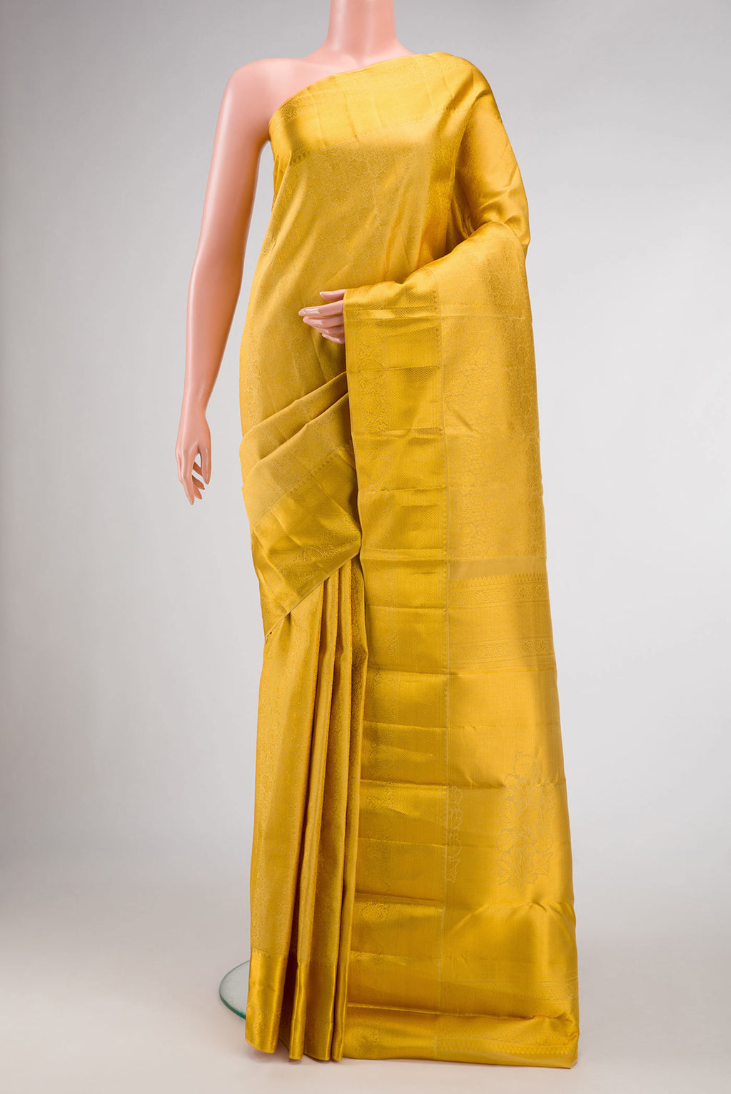 Gold Dual Tone Kanjivaram Silk Saree with Zari Brocade on the body and Zari Border.  displayed on a mannequin