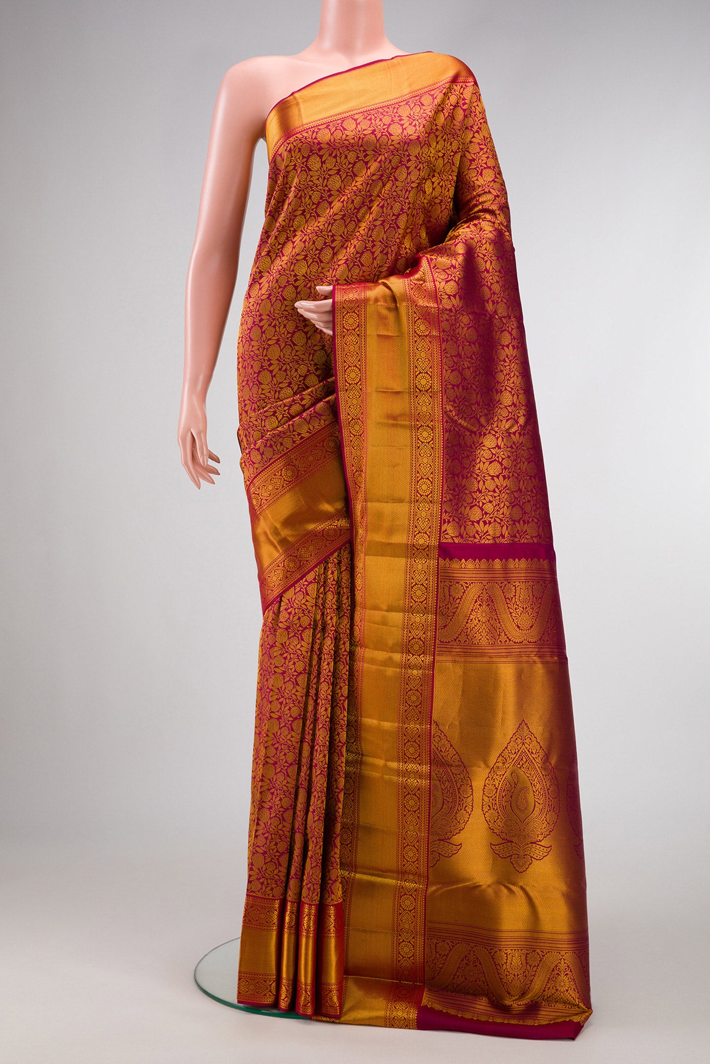 Maroon Dual Tone Kanjivaram Silk Saree with Zari Brocade on the body and Zari Border.  displayed on a mannequin