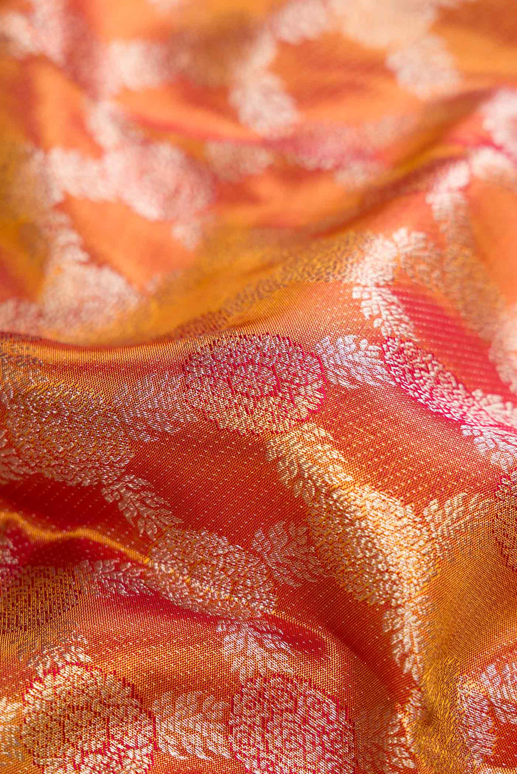 Close up of Gold Dual Tone Kanchipuram Tissue Silk Saree with Zari Brocade on the body and Zari Border.  displaying folds