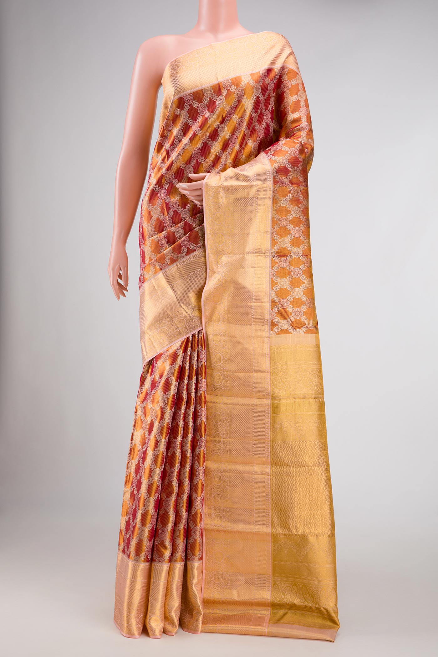 Gold Dual Tone Kanchipuram Tissue Silk Saree with Zari Brocade on the body and Zari Border.  displayed on a mannequin