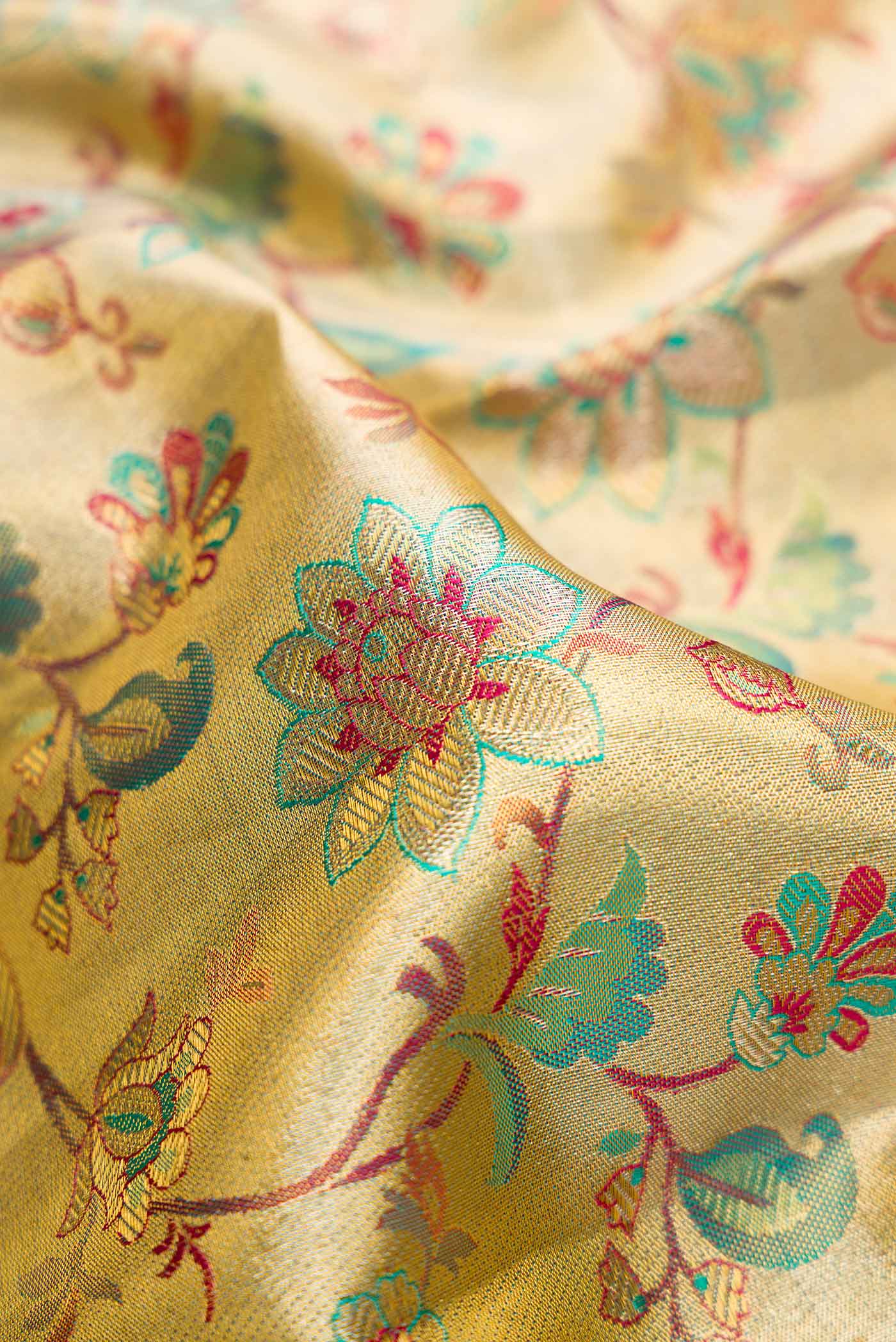 Close up of Gold Dual Tone Kanchipuram Tissue Silk Saree with Zari Brocade on the body and Zari Border.  displaying folds